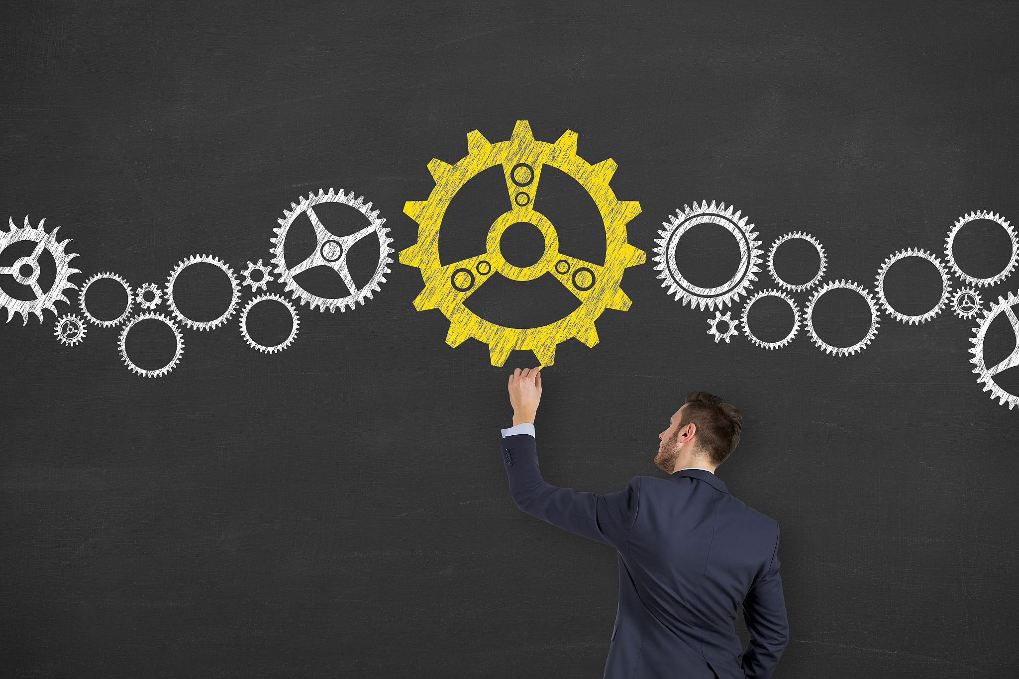 businessman solution gear concept on chalkboard background