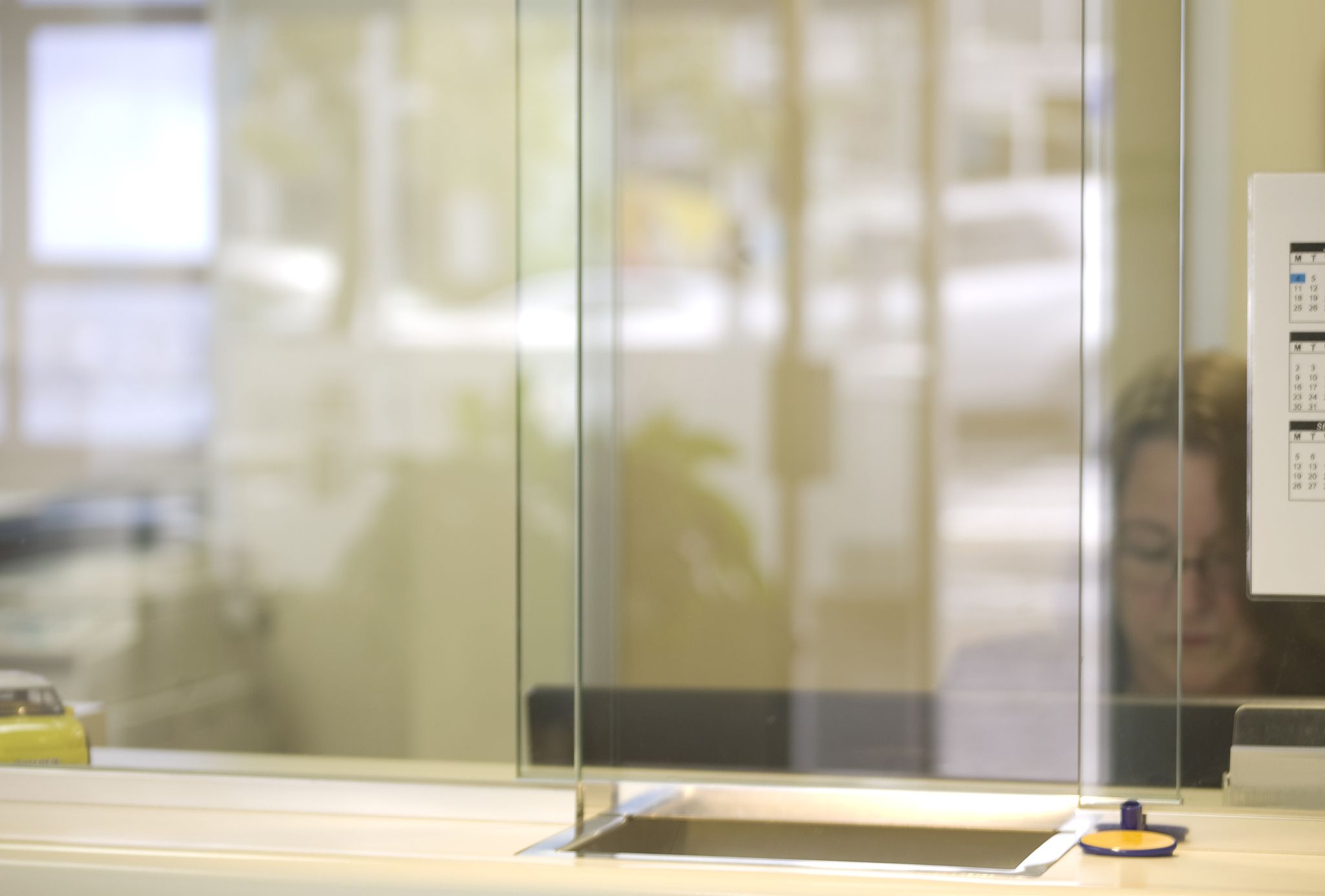 woman works in office viewed through glass
