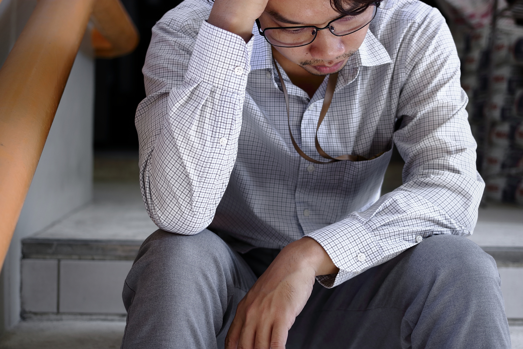 close up depressed young asian business man suffering from sever