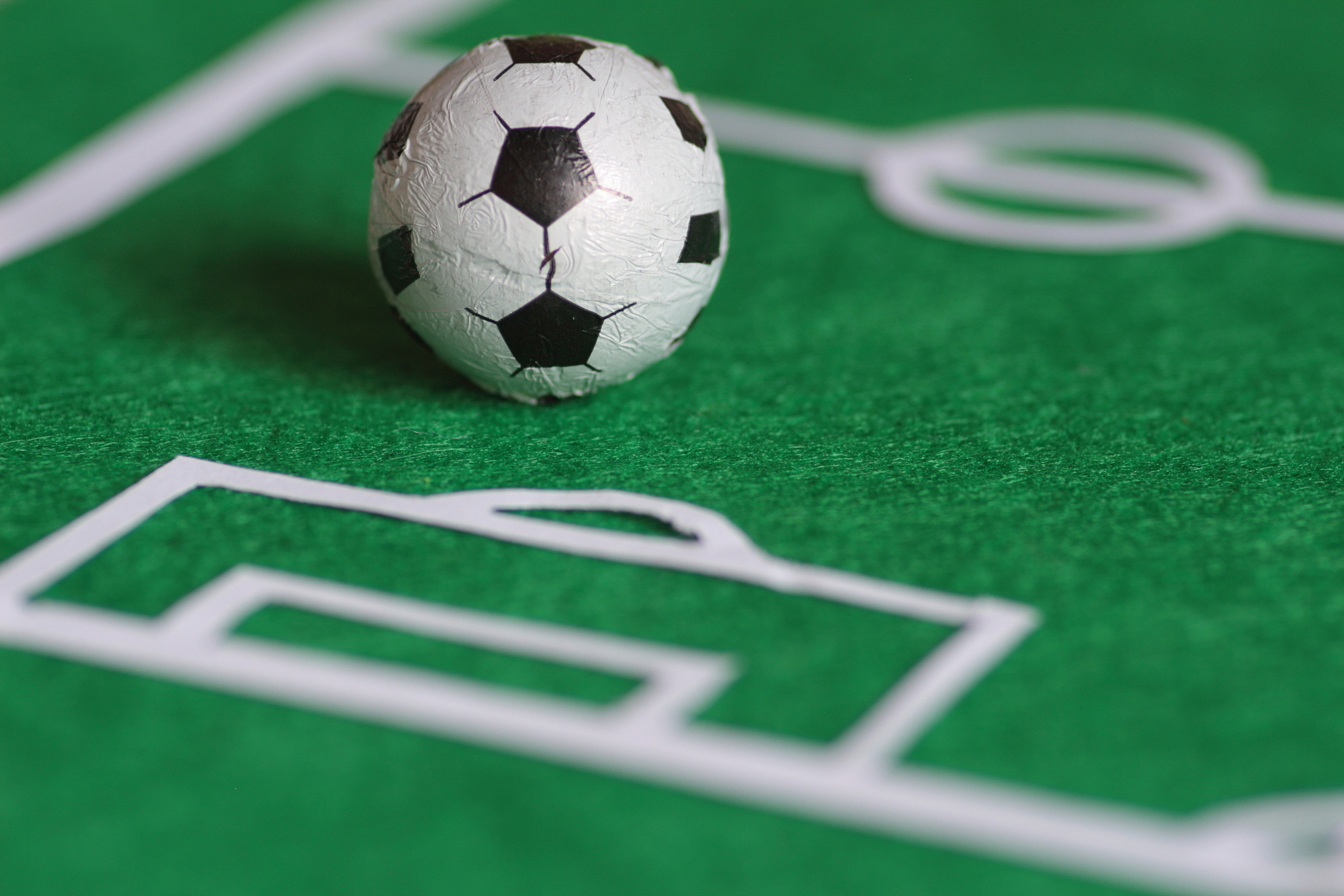 football field plan with a toy soccer ball