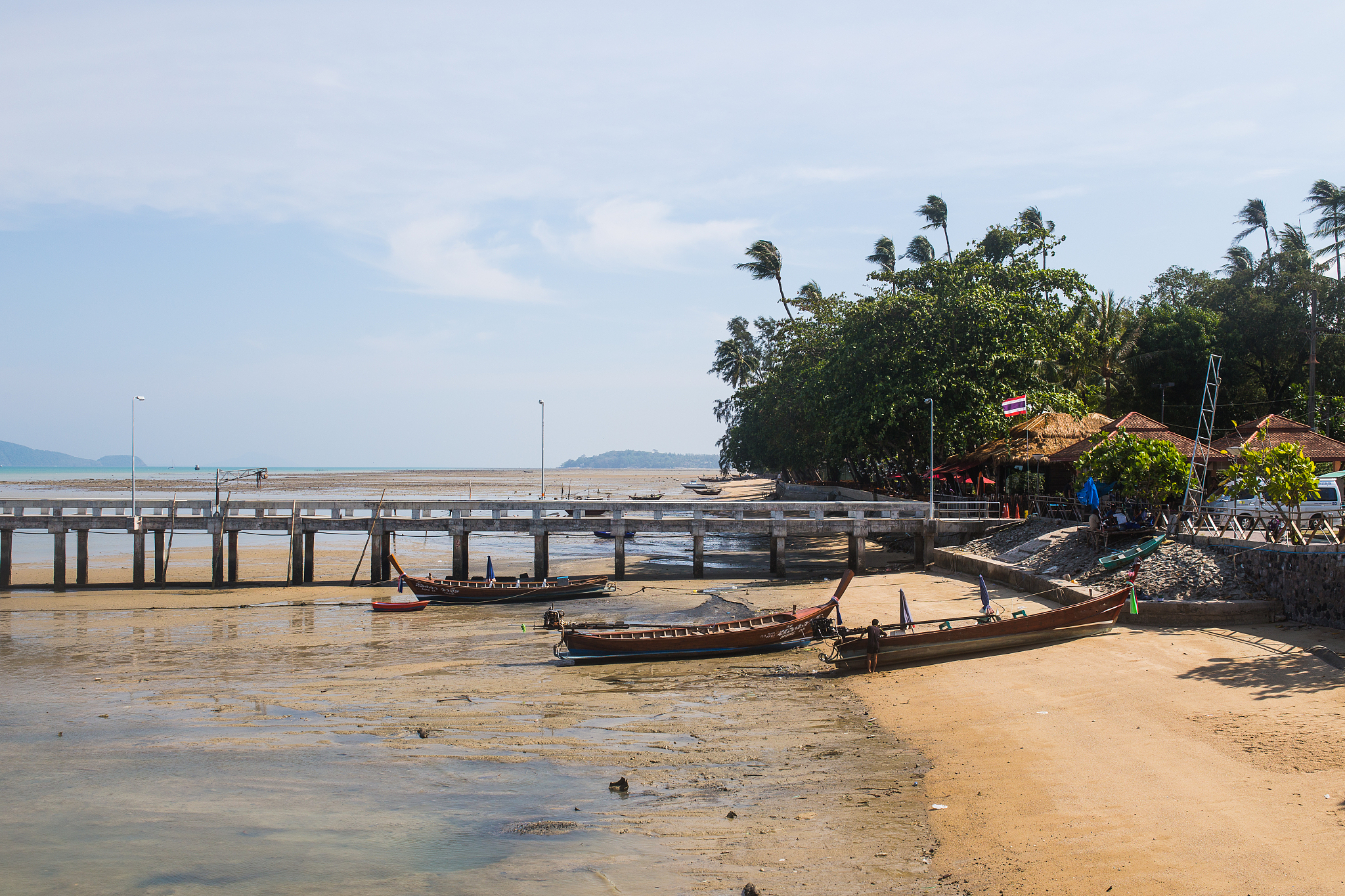 bridge over beach with boat