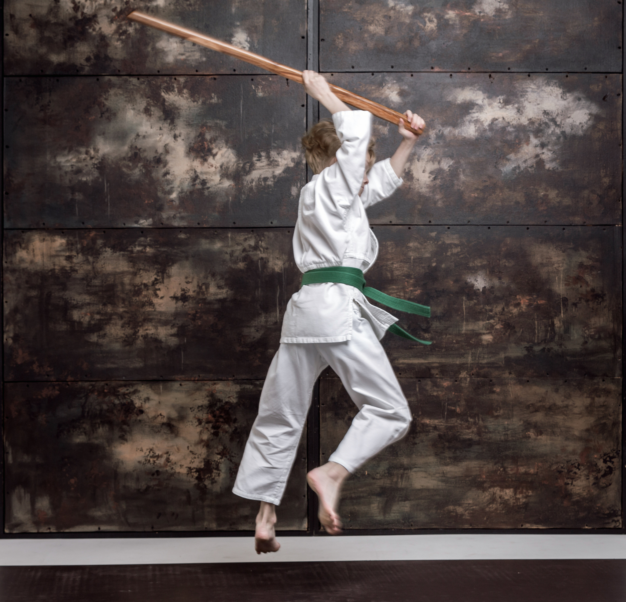 training fight. aikido boy is using wooden bokken