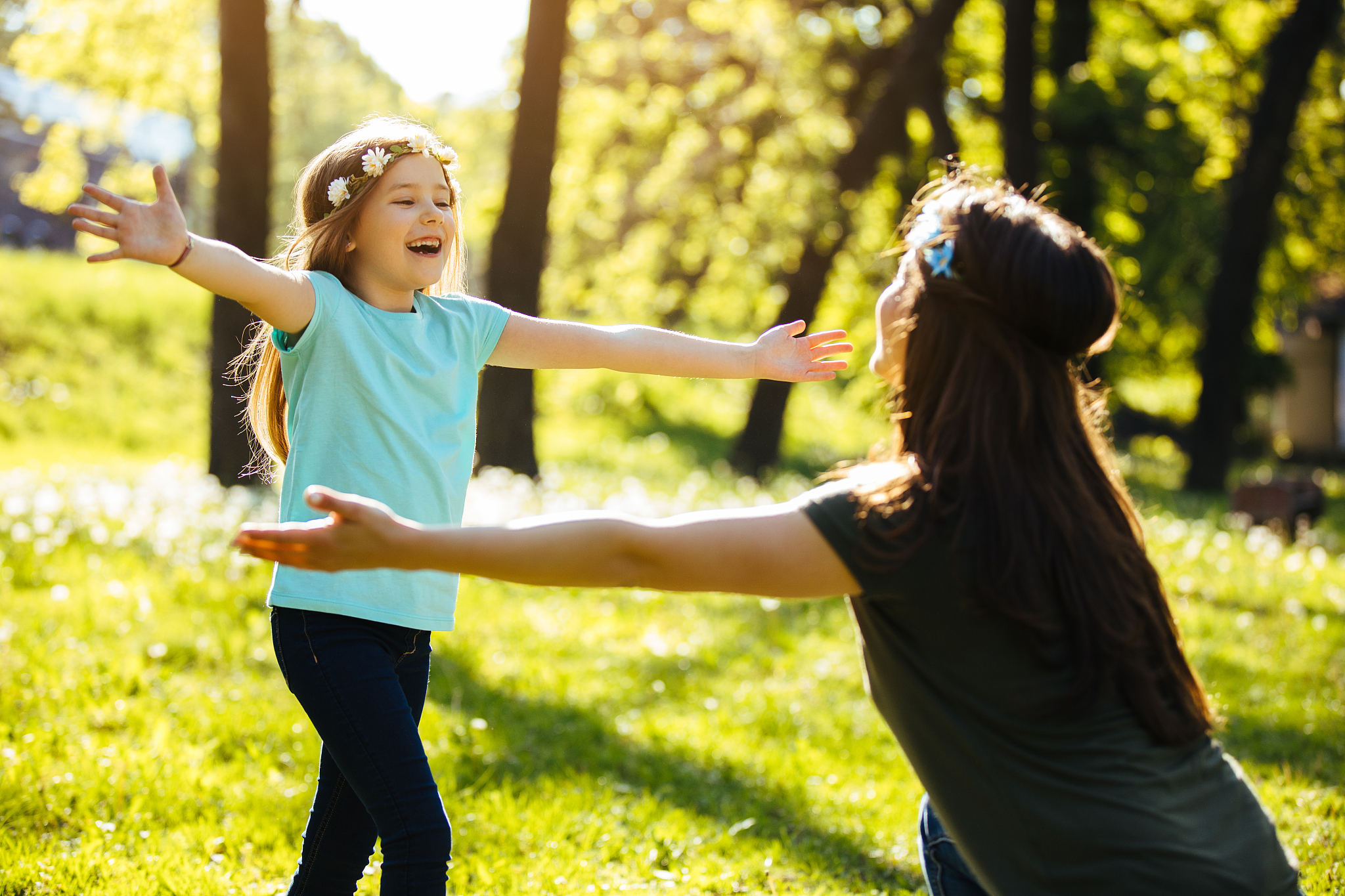 mother and daughter in a park hugging