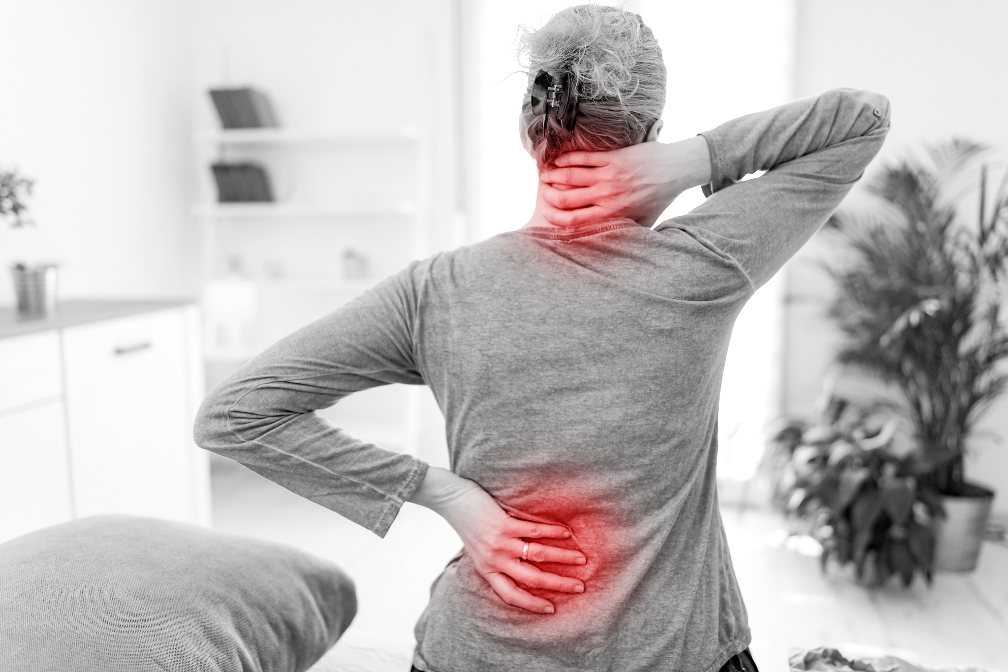 woman waking up on the bed, morning stretching, pain in the back
