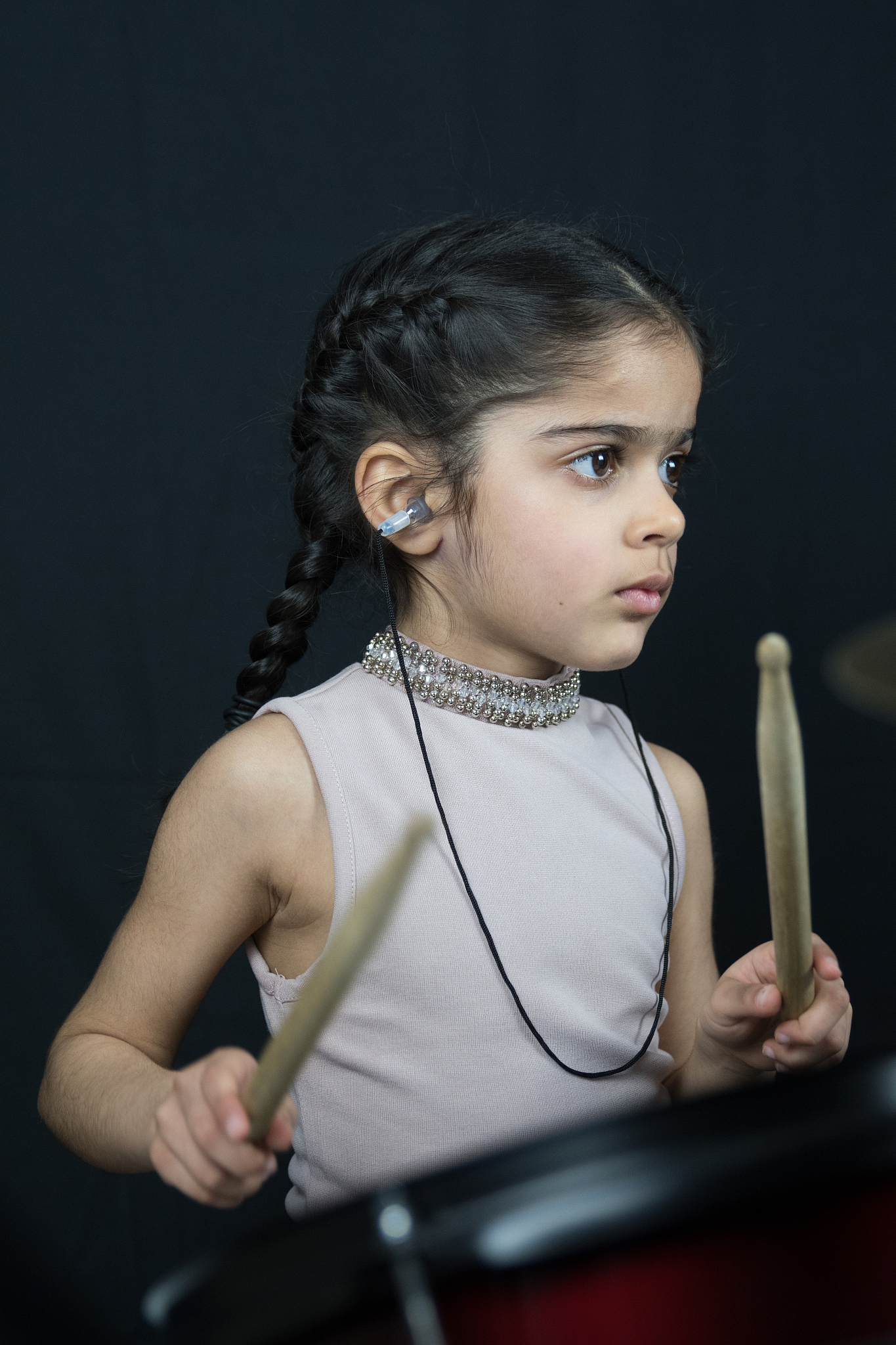 5 year old girl practices the drums
