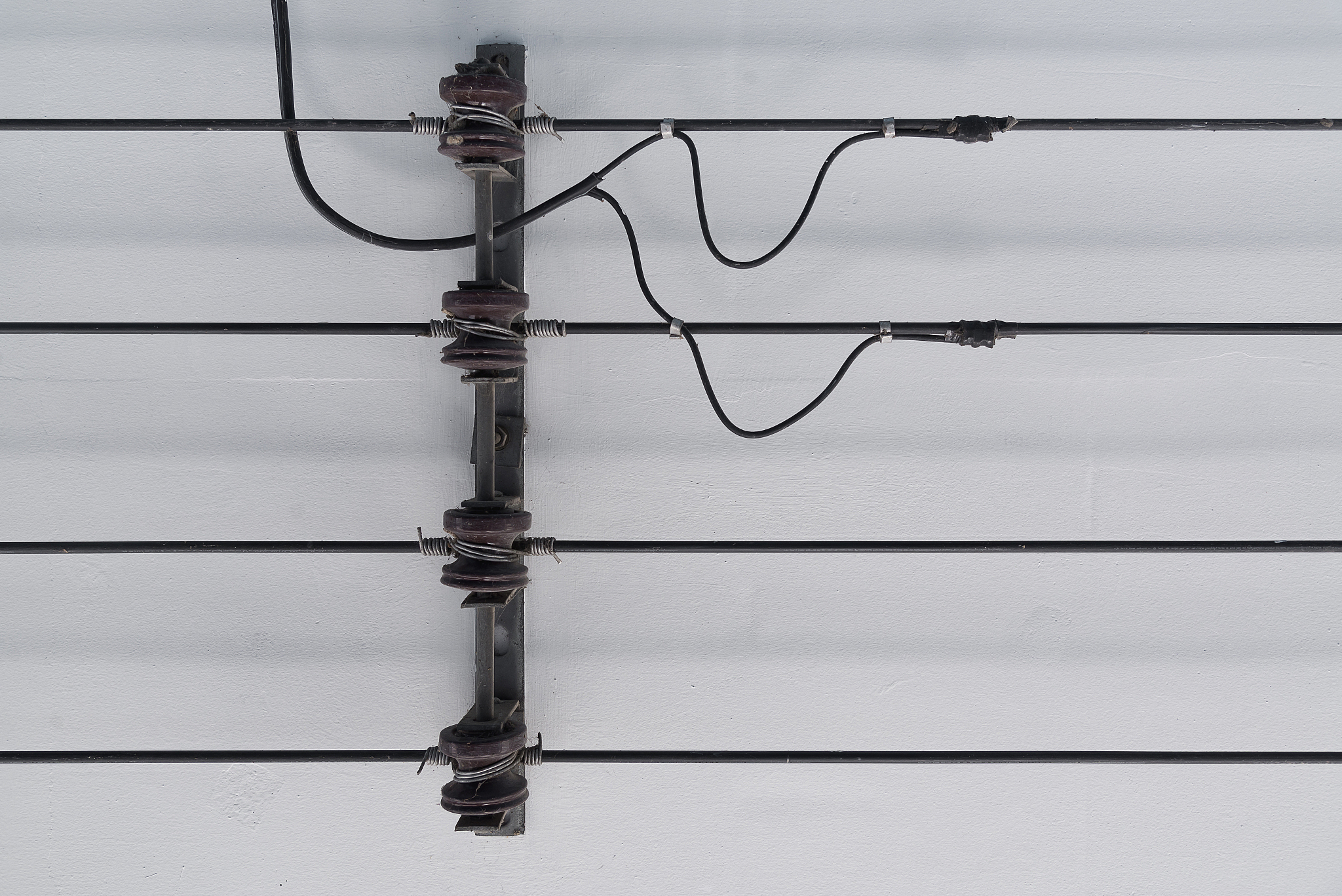 power line and porcelain insulators with rack on ceiling.