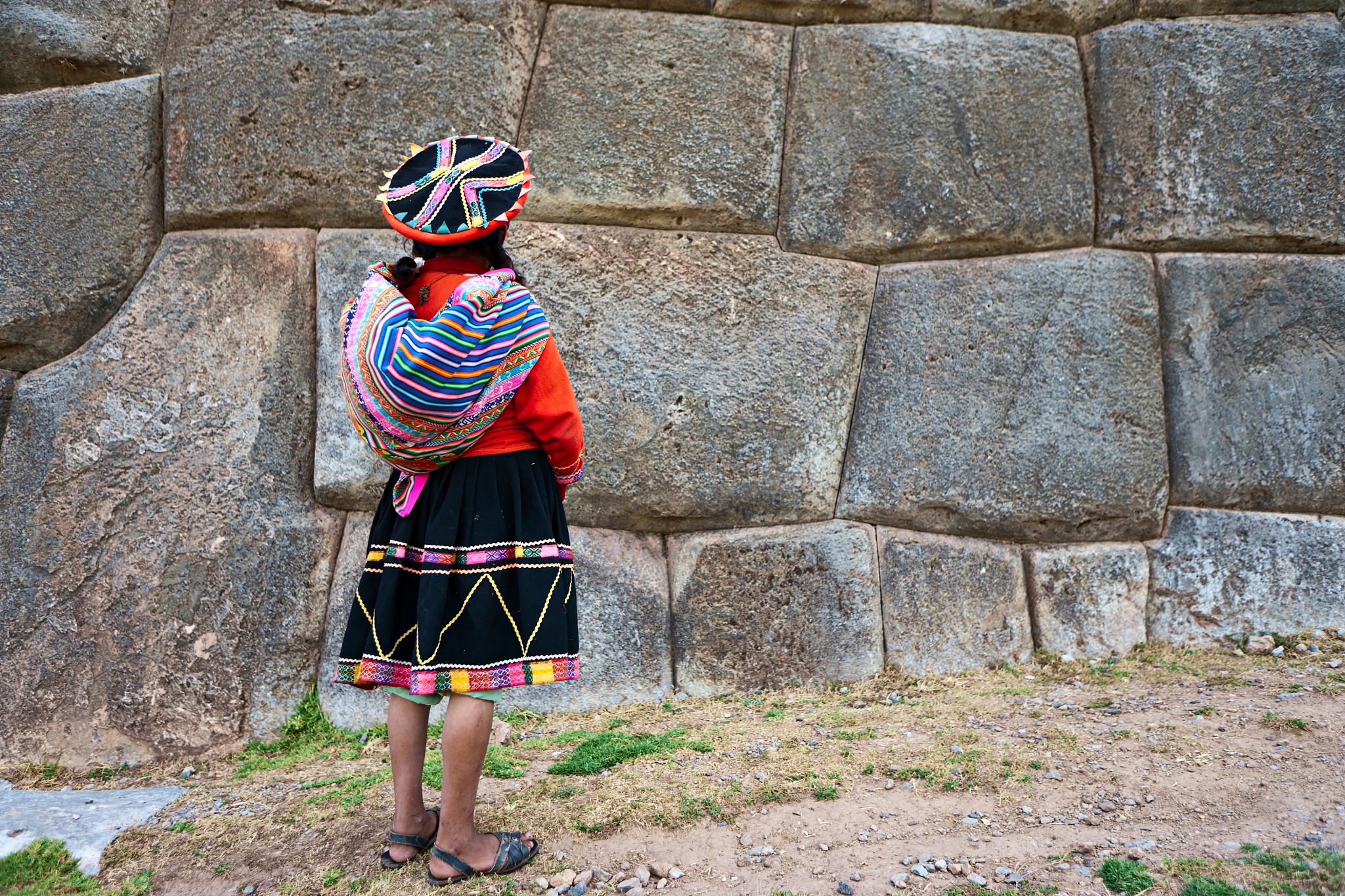 portrait of peruvian woman in national costume, sacsayhuaman