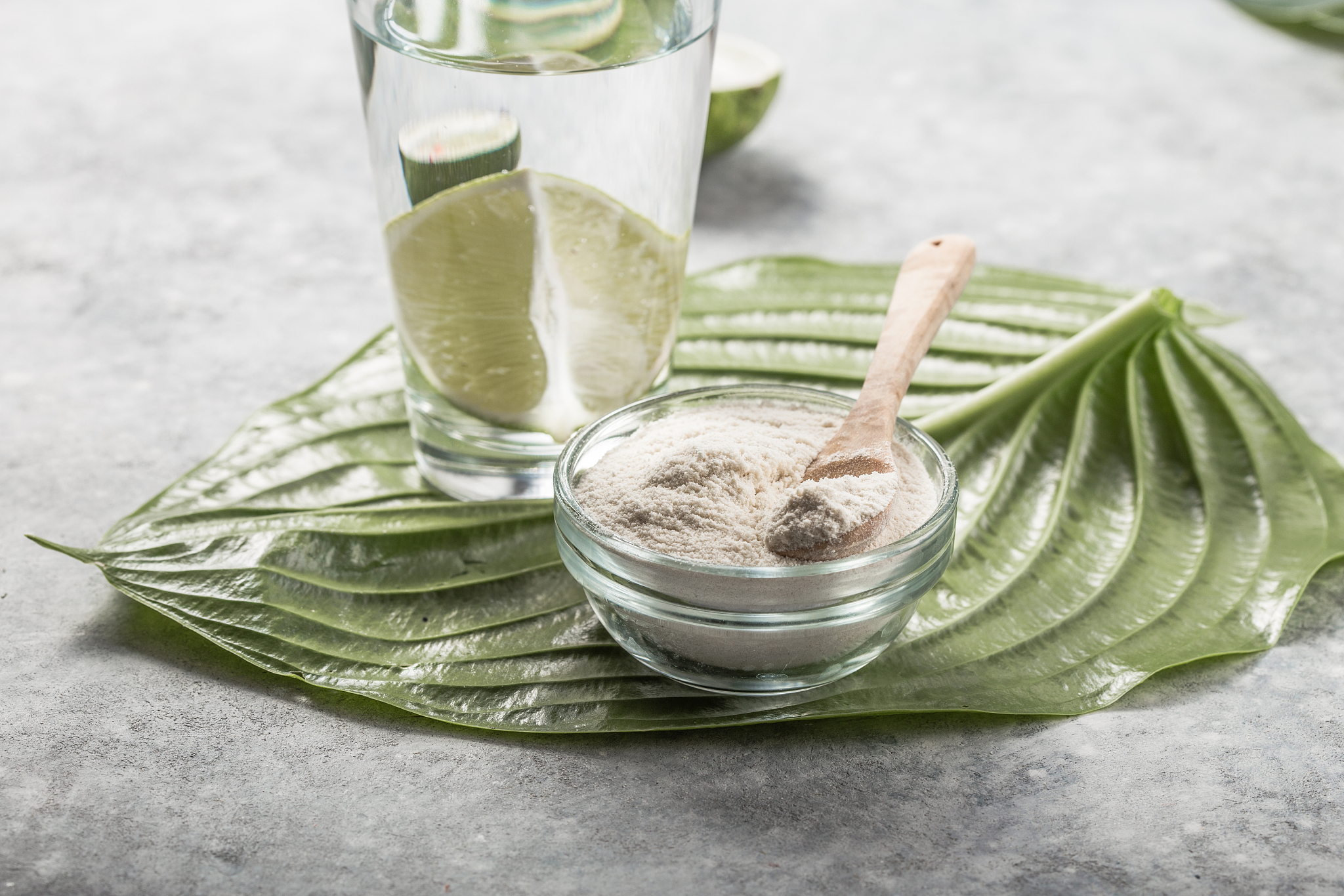 collagen powder and glass of water with  slice of lime; vitamin 