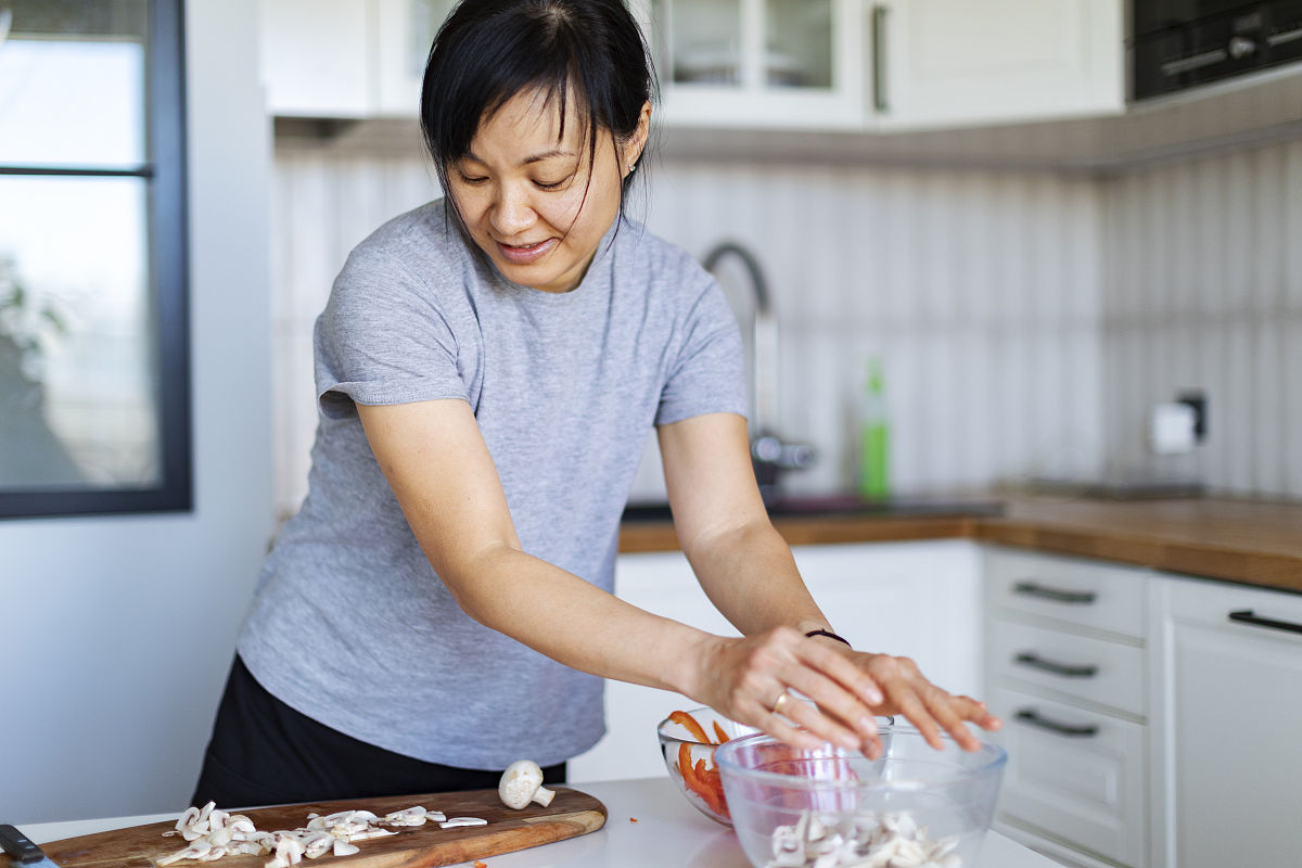 请描写一下厨房内年轻人感谢老婆婆开导的画面
