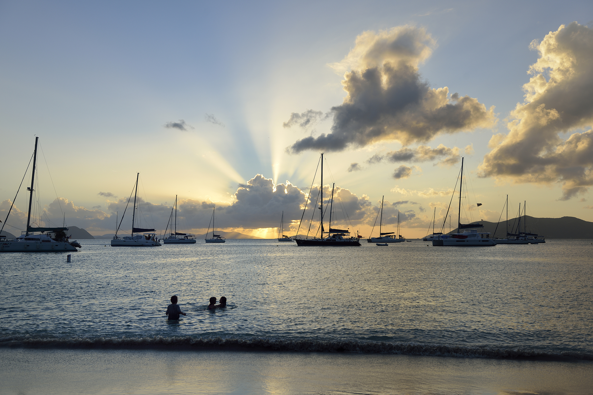 kids playing in water at cane garden bay, tortola, british virgi