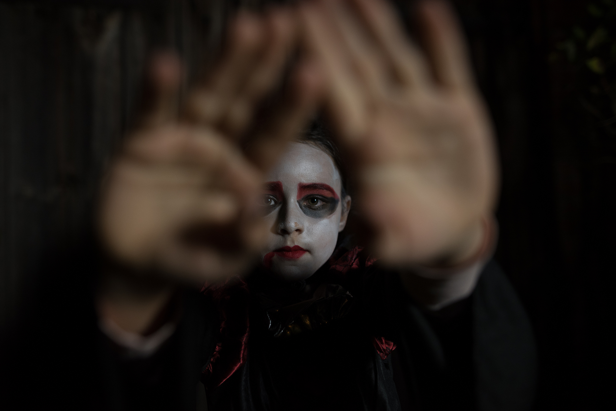 halloween – little girl at night – hands in front of the face
