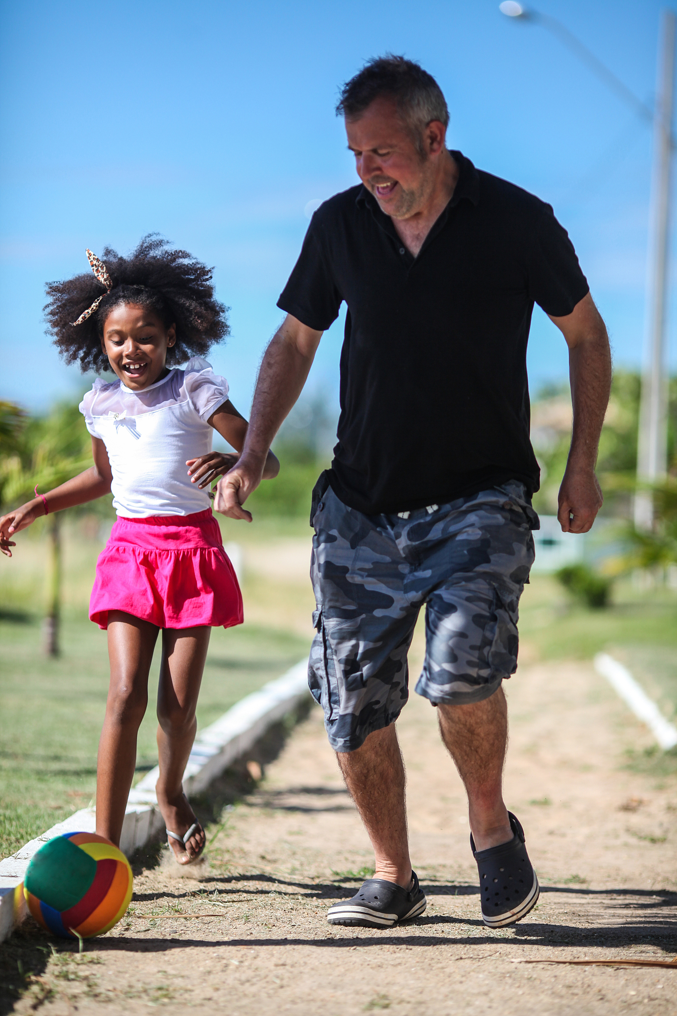 father and daughter playing with football