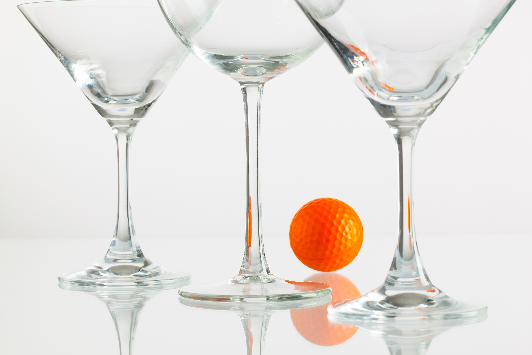 three glasses of champagne and golf equipments