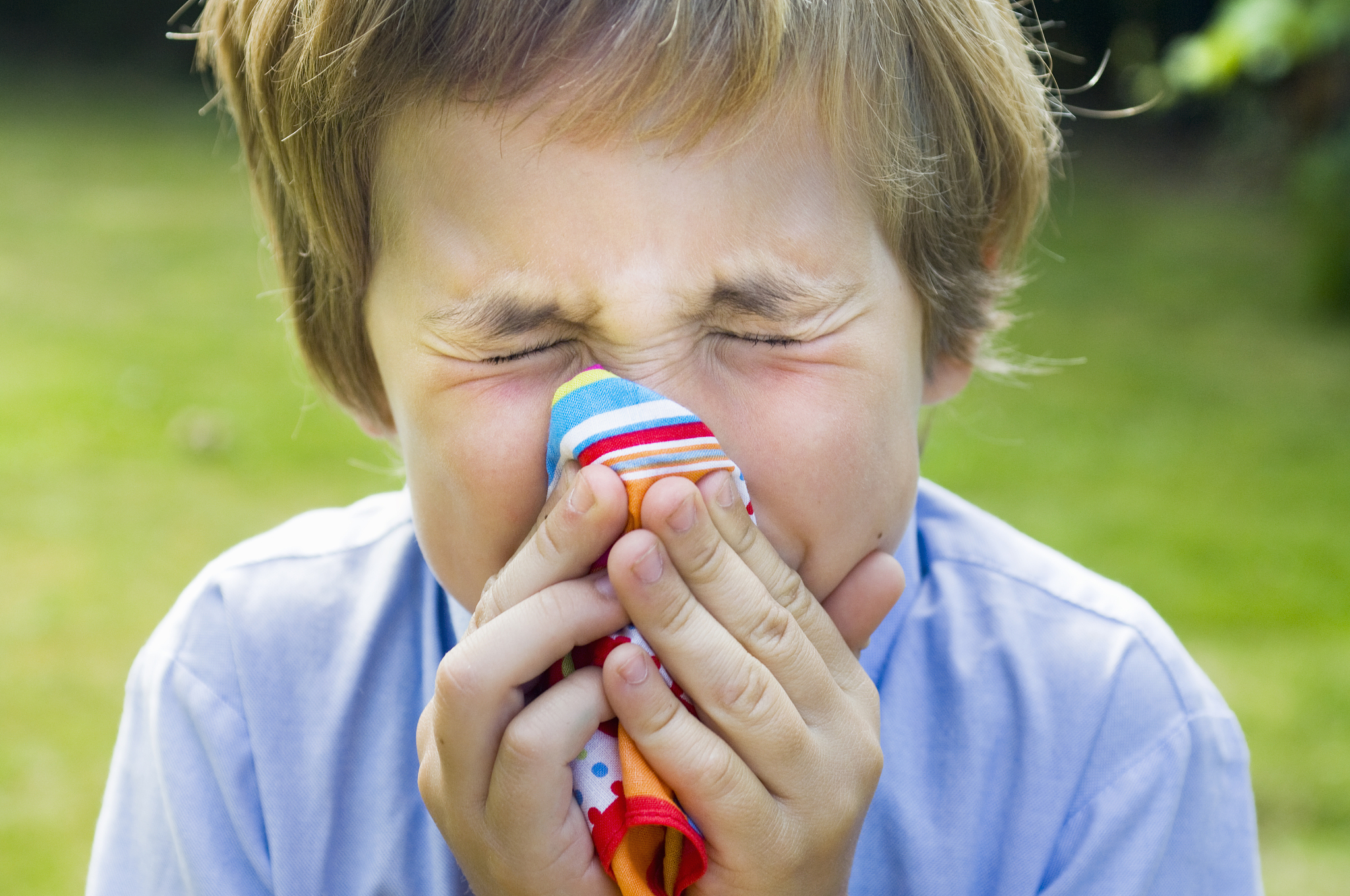 child blowing nose