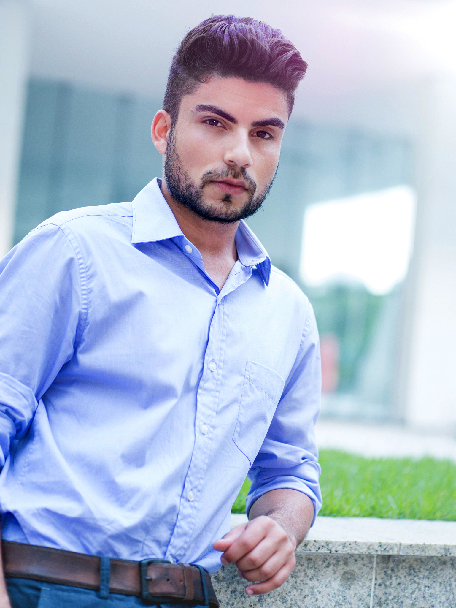 young serious hispanic businessman looking at the camera.