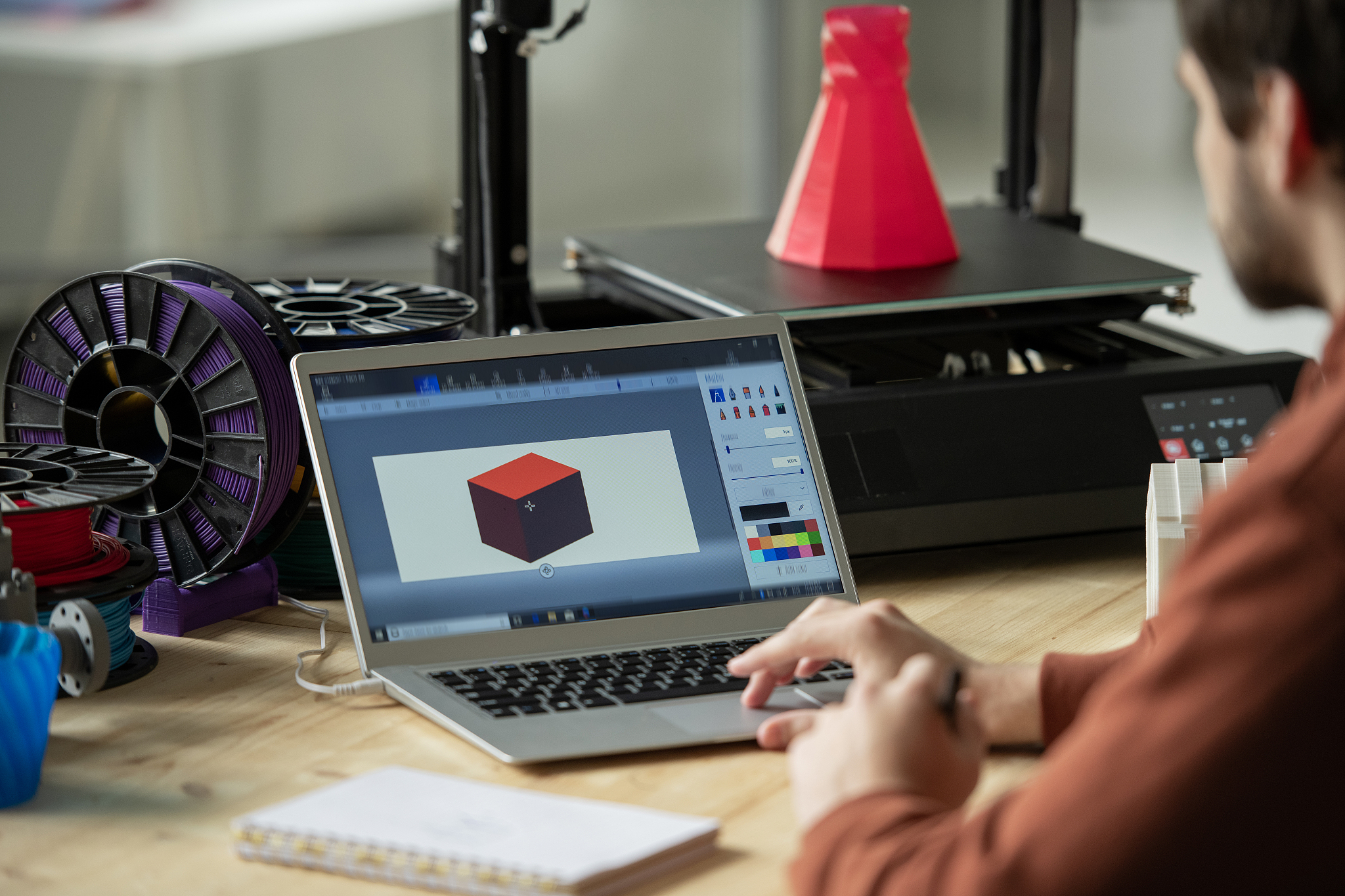 creative designer working over new 3d model on laptop screen bef