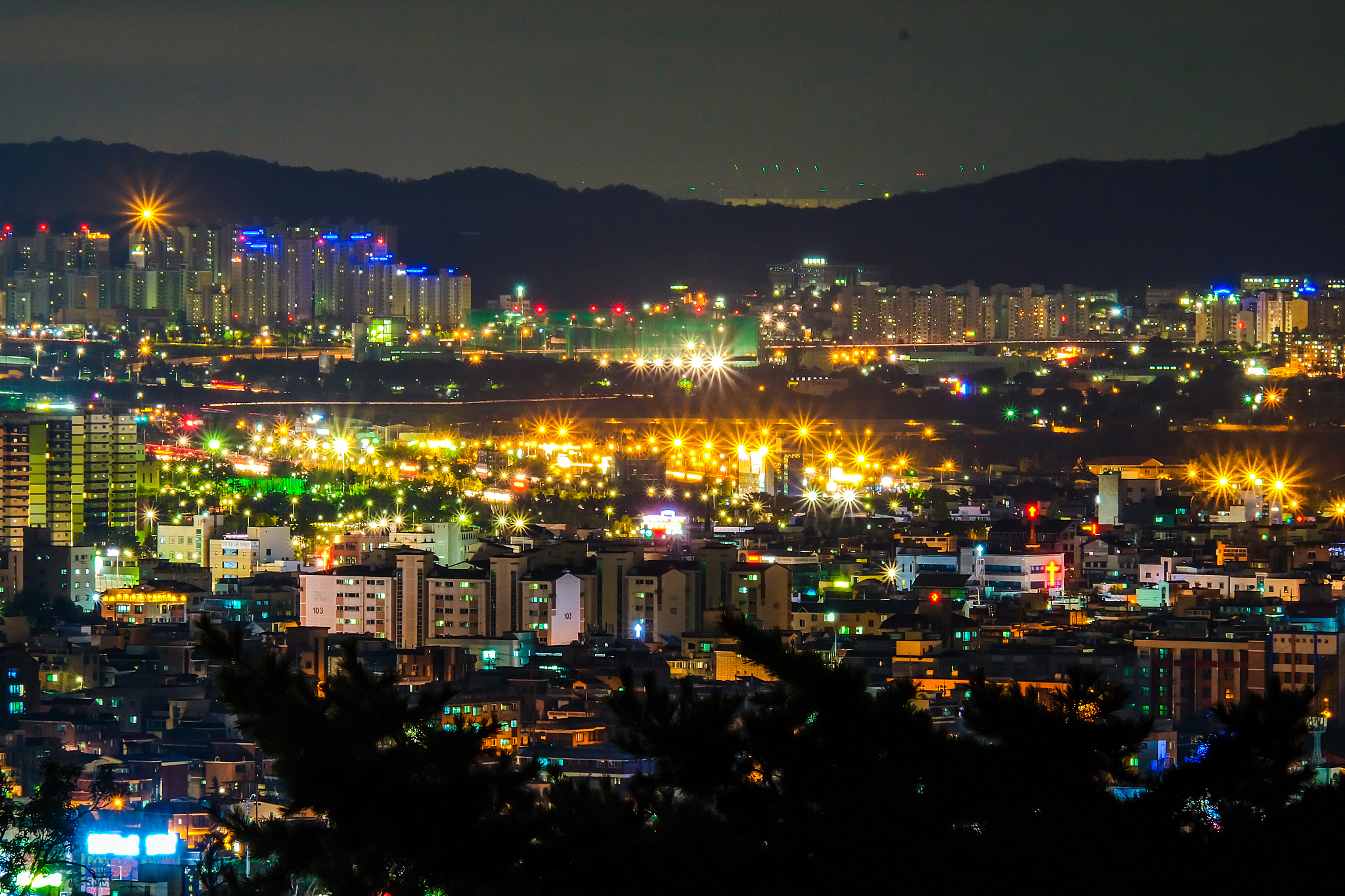 illuminated cityscape against sky at night