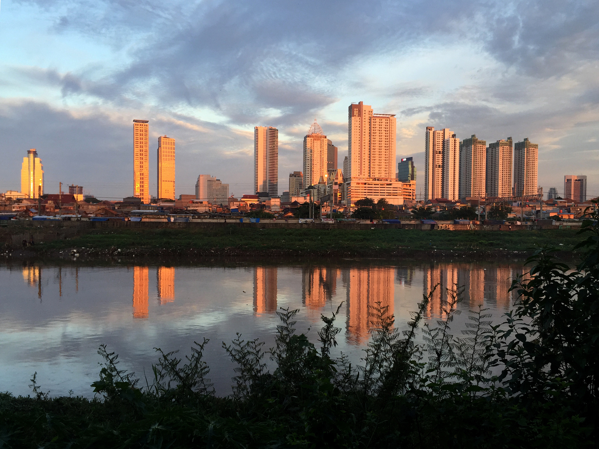 reflection of buildings in city against sky
