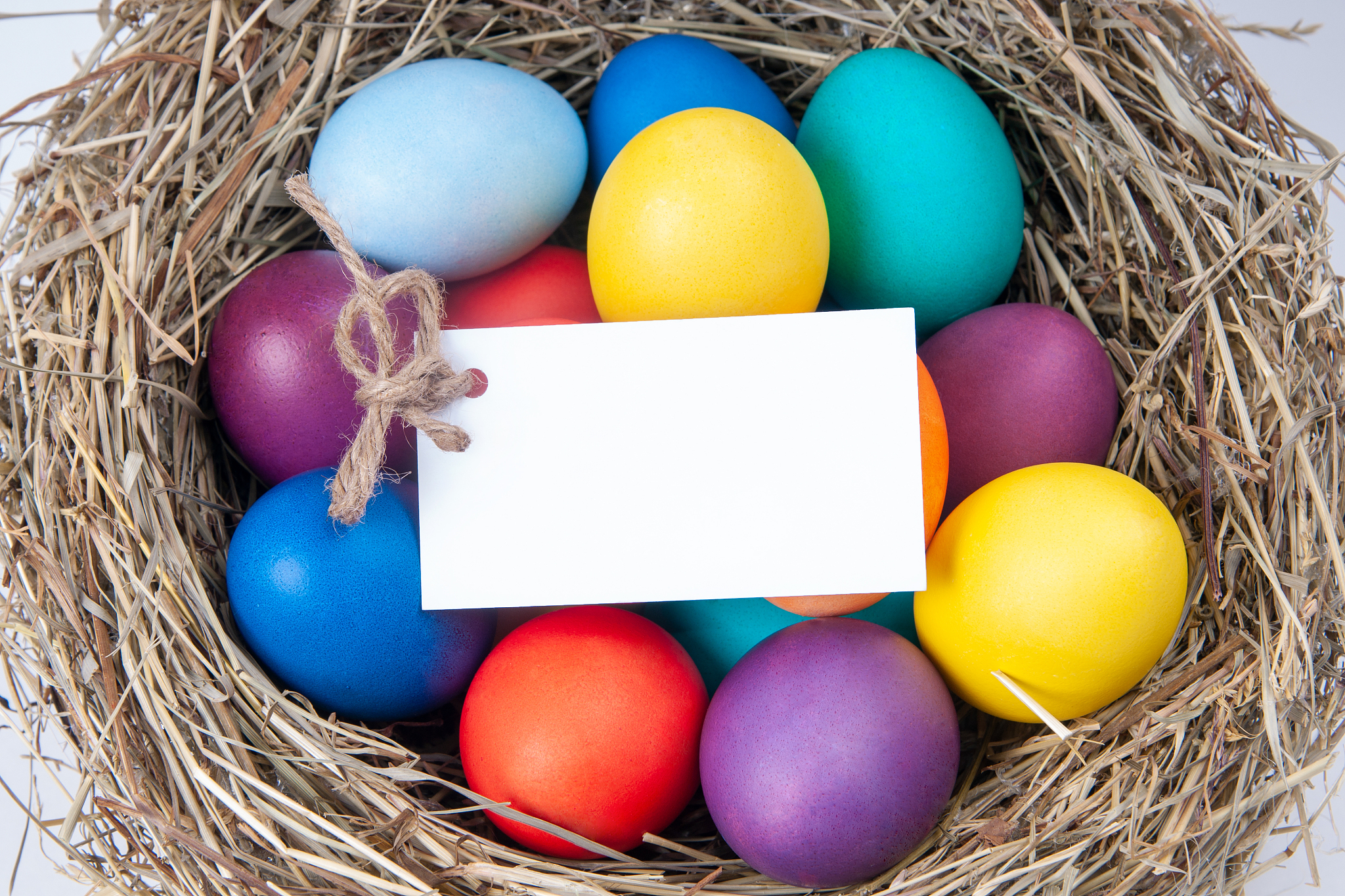 multicolored eggs with a note in the hay. mock up, concept easte