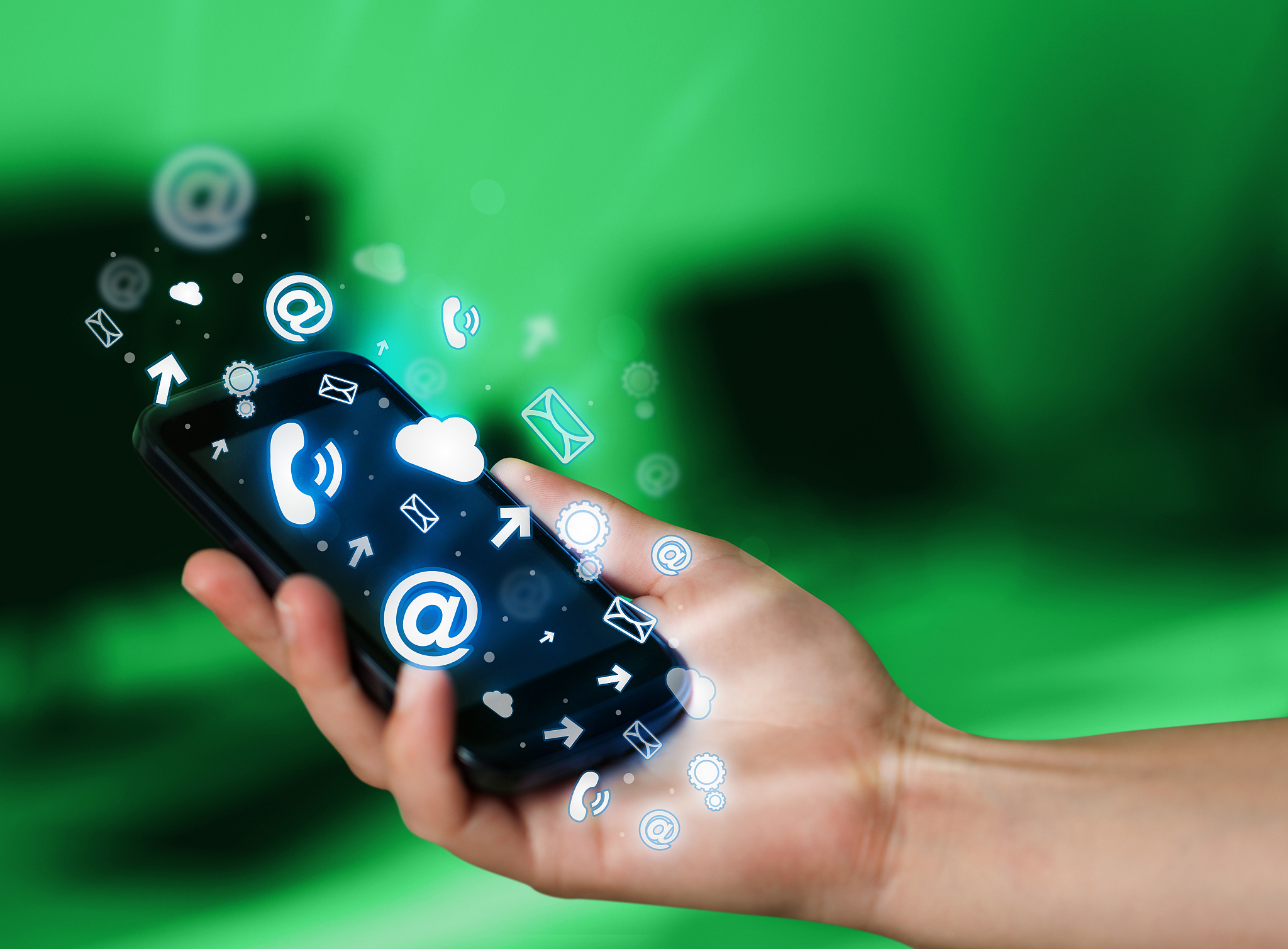 business man holding smart phone with media icons