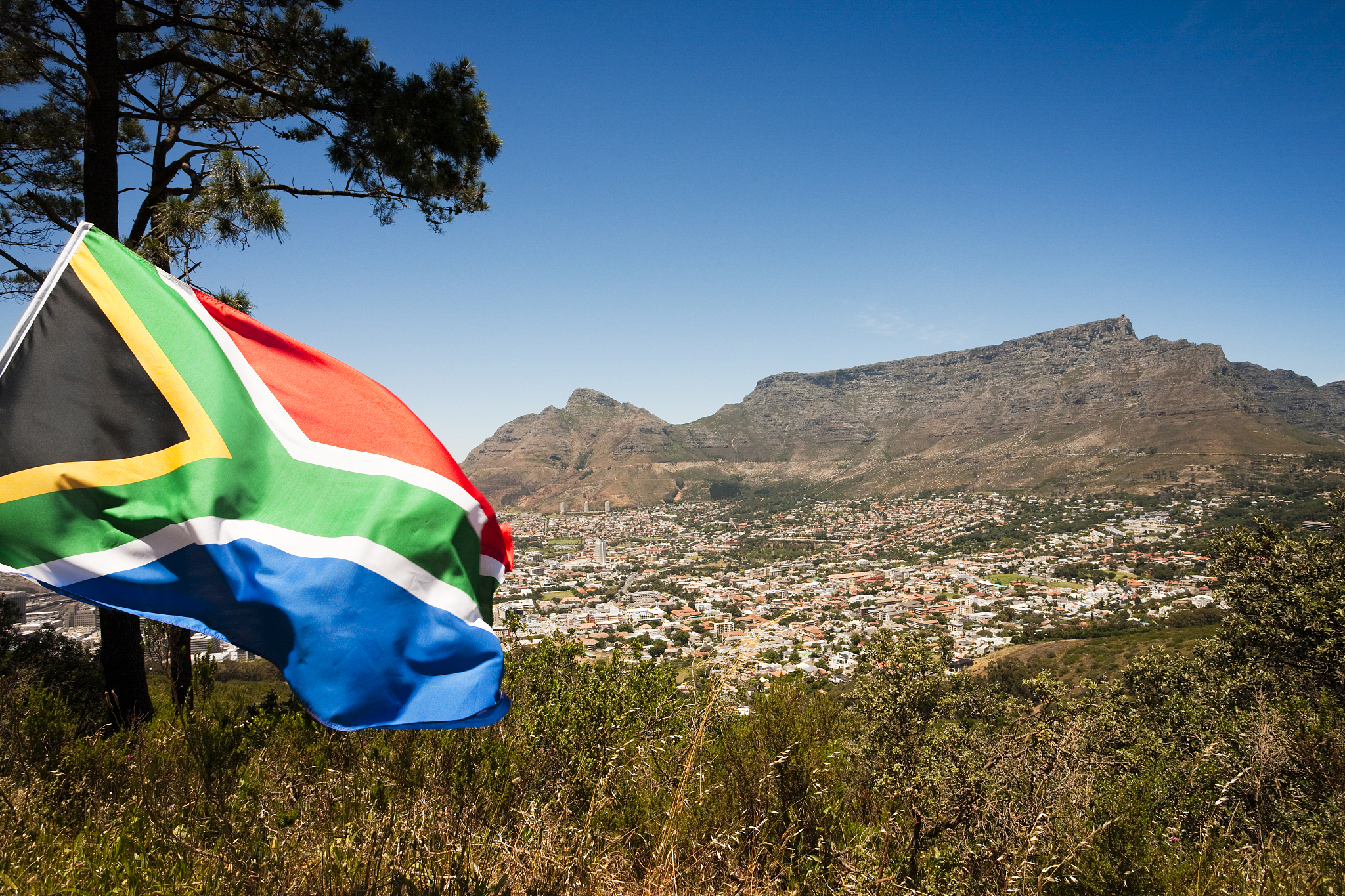south african flag against table mountain, cape town