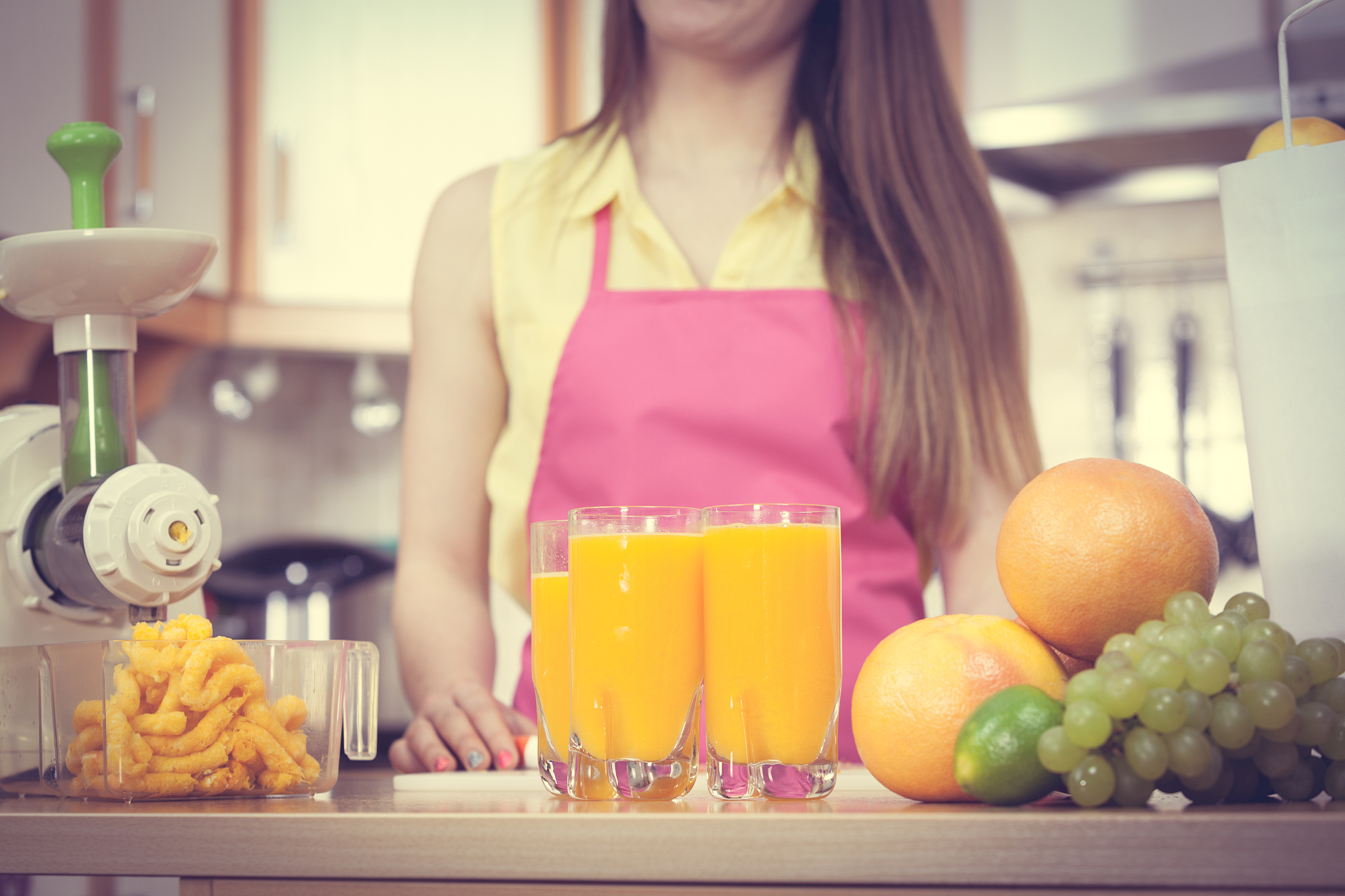 woman pouring orange juice drink in glass