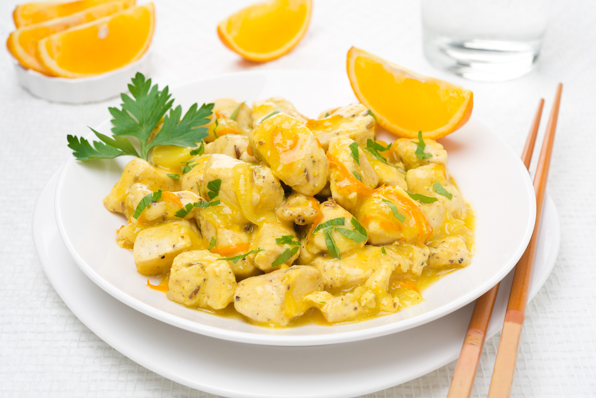 chicken fillet with orange sauce and parsley on the plate