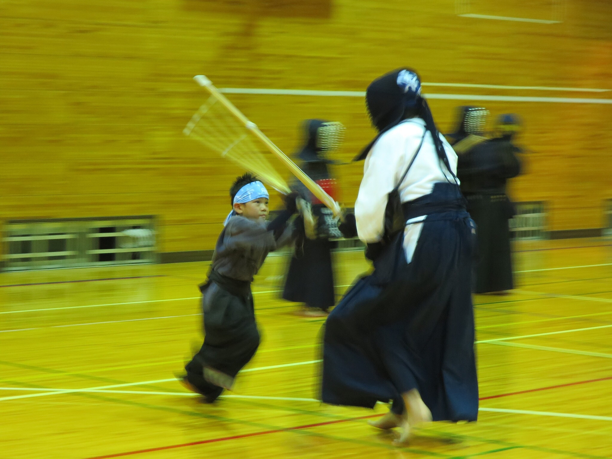 people practicing kendo in court