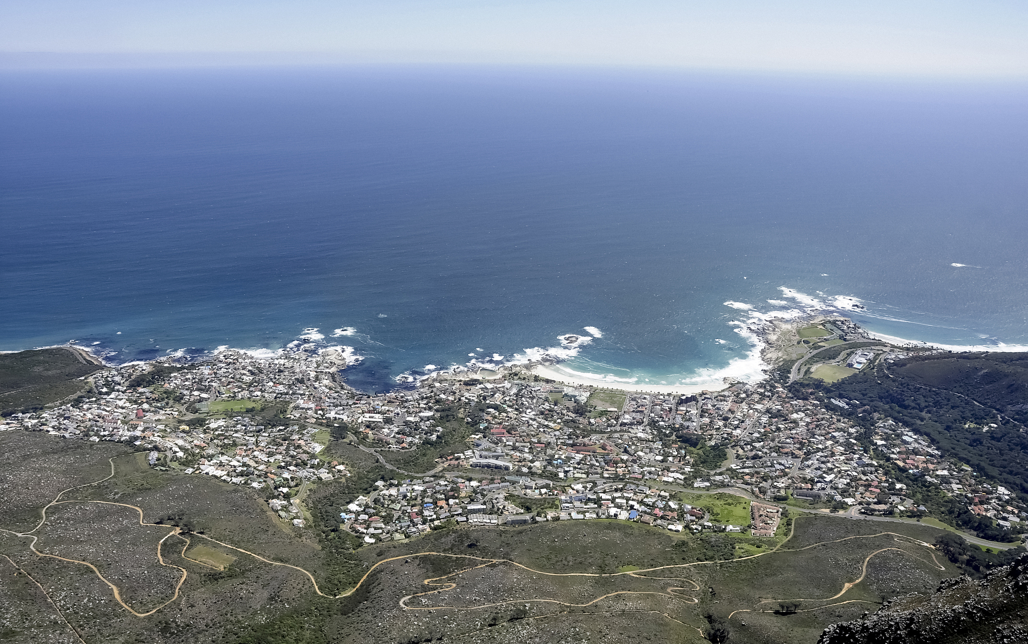high angle view of sea and cityscape against sky