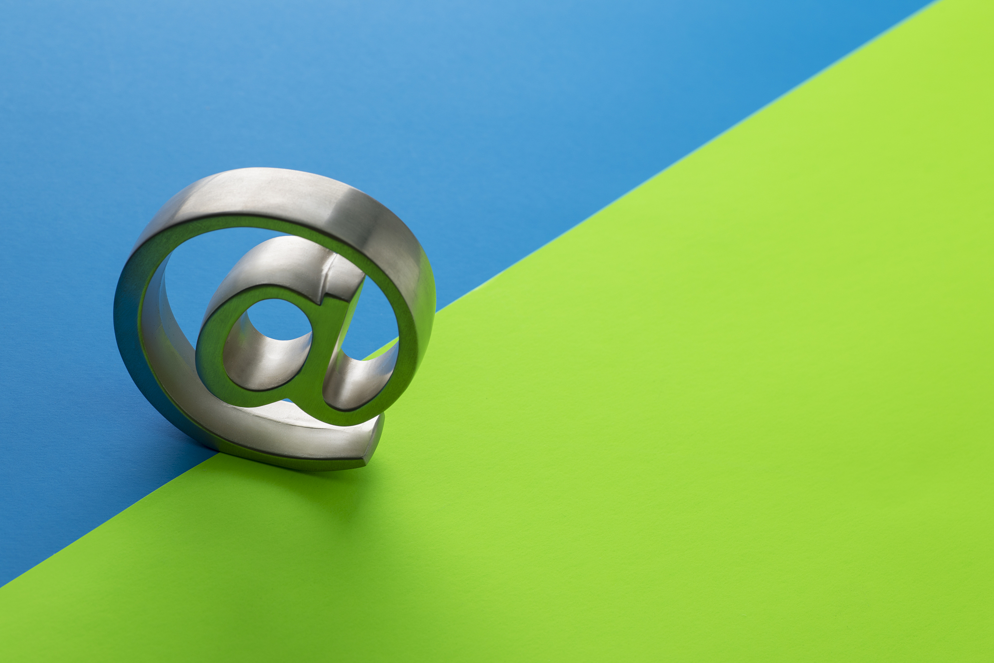 email symbol on blue green split diagonal background