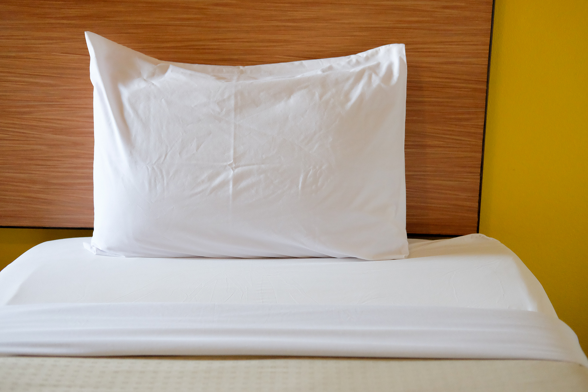 white bedding sheets and pillow