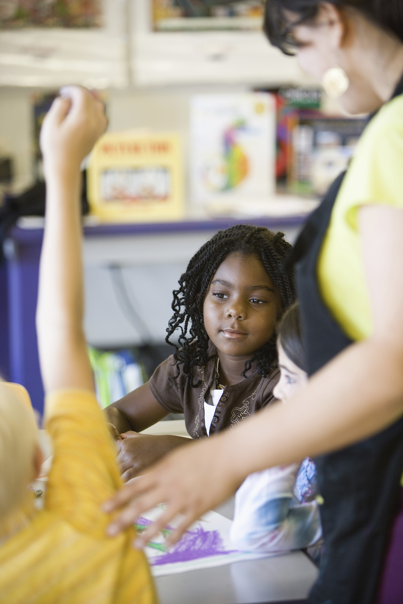 close up of children and teacher in classroom
