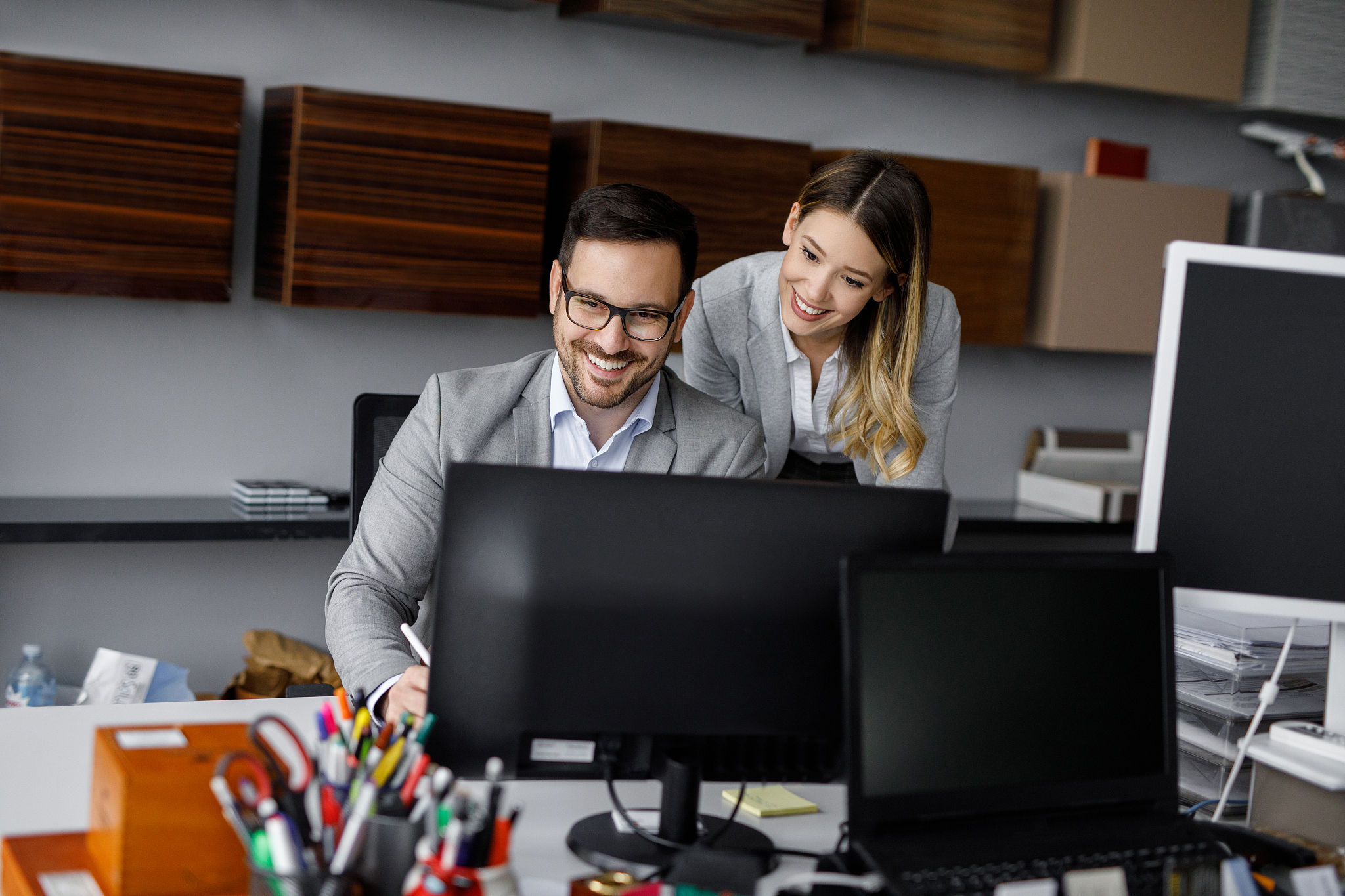 two business people working together in the office using compute