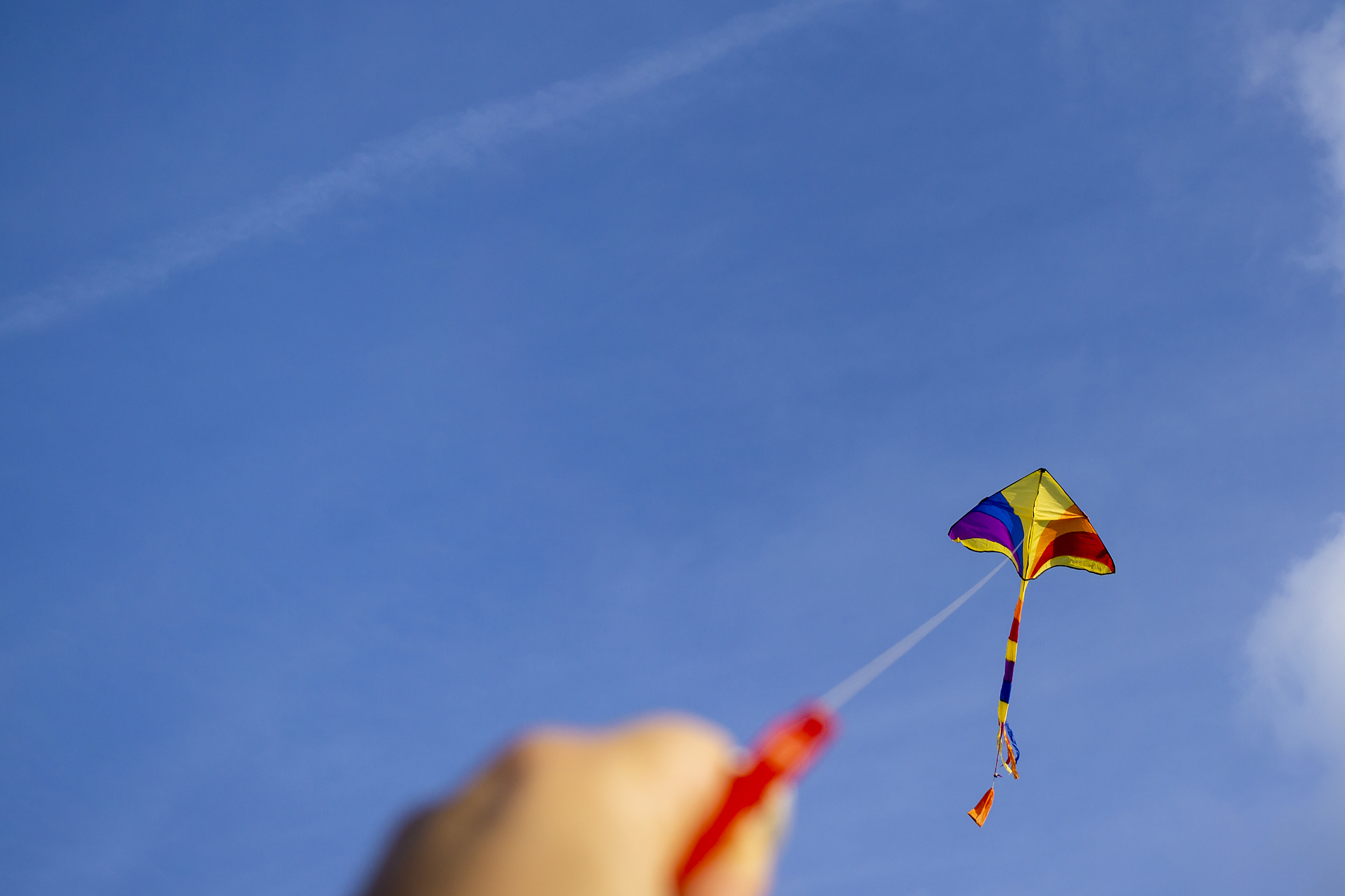 kite flying in a beautiful sky clouds. focus on the kite