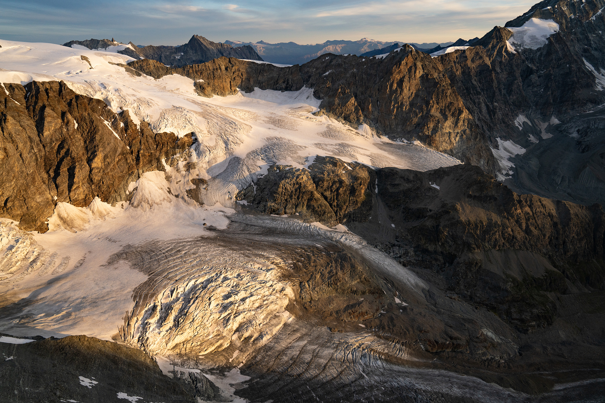 aerial flying over glacier in switzerland at sunrise