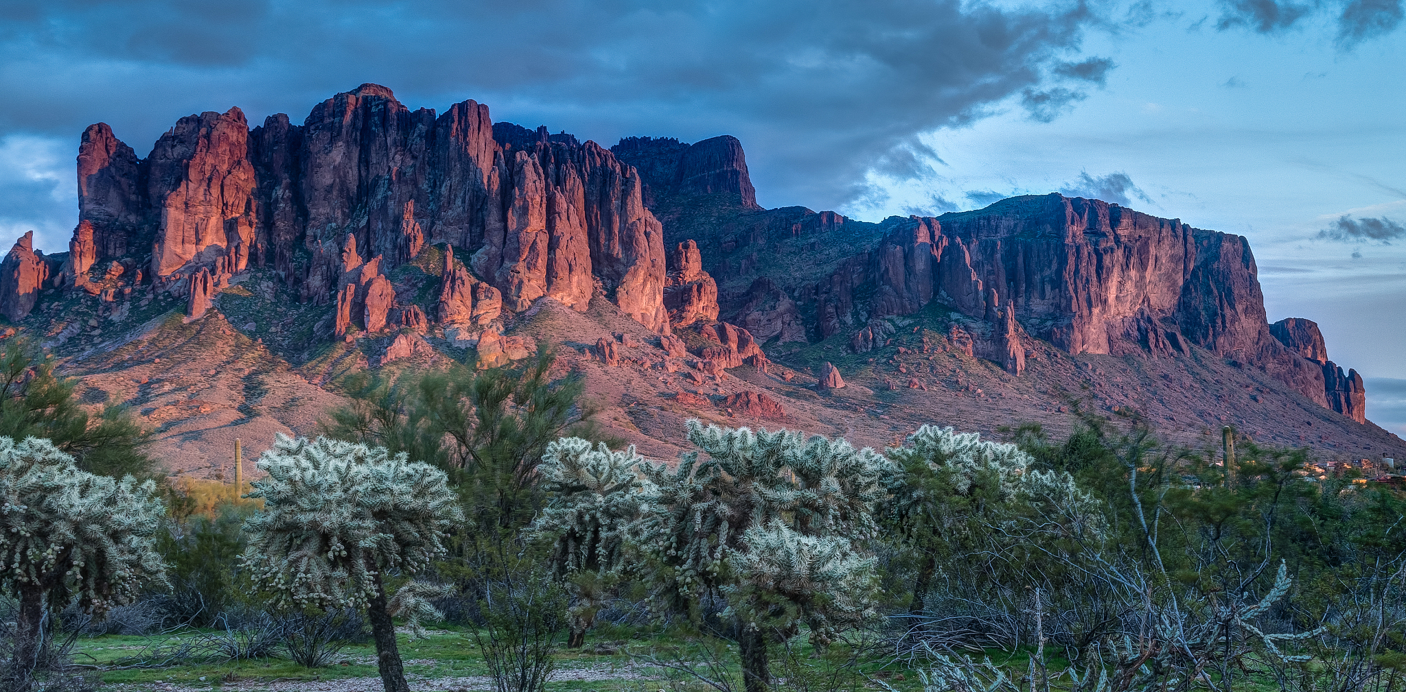 sun sets on the superstition mountains