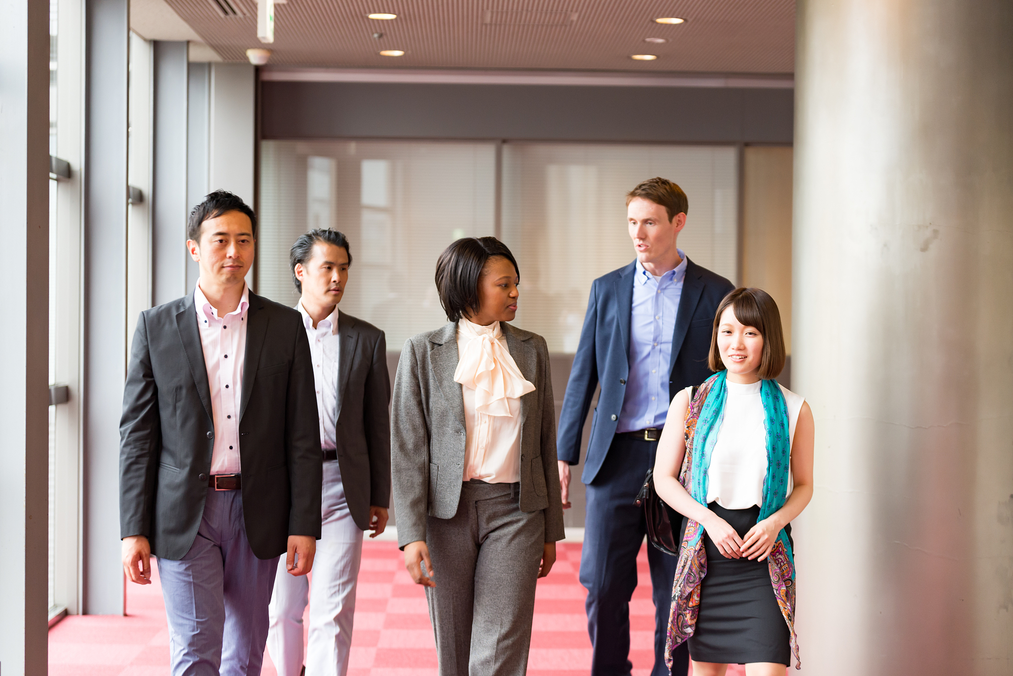 international businesspeople are walking together at hallway of 