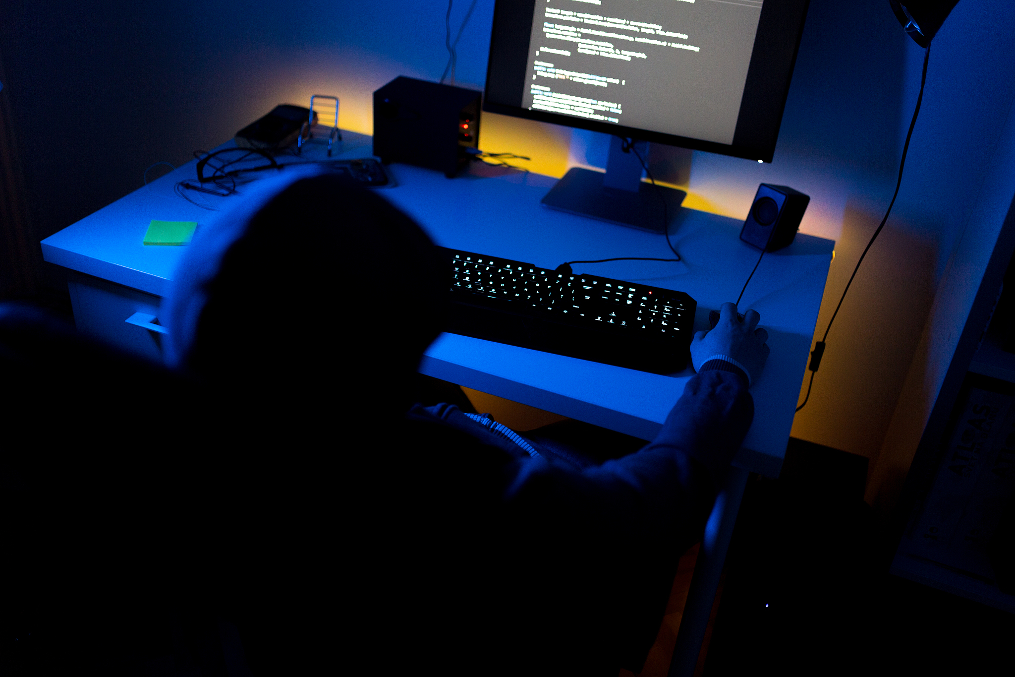 professional computer hacker doing his job at home