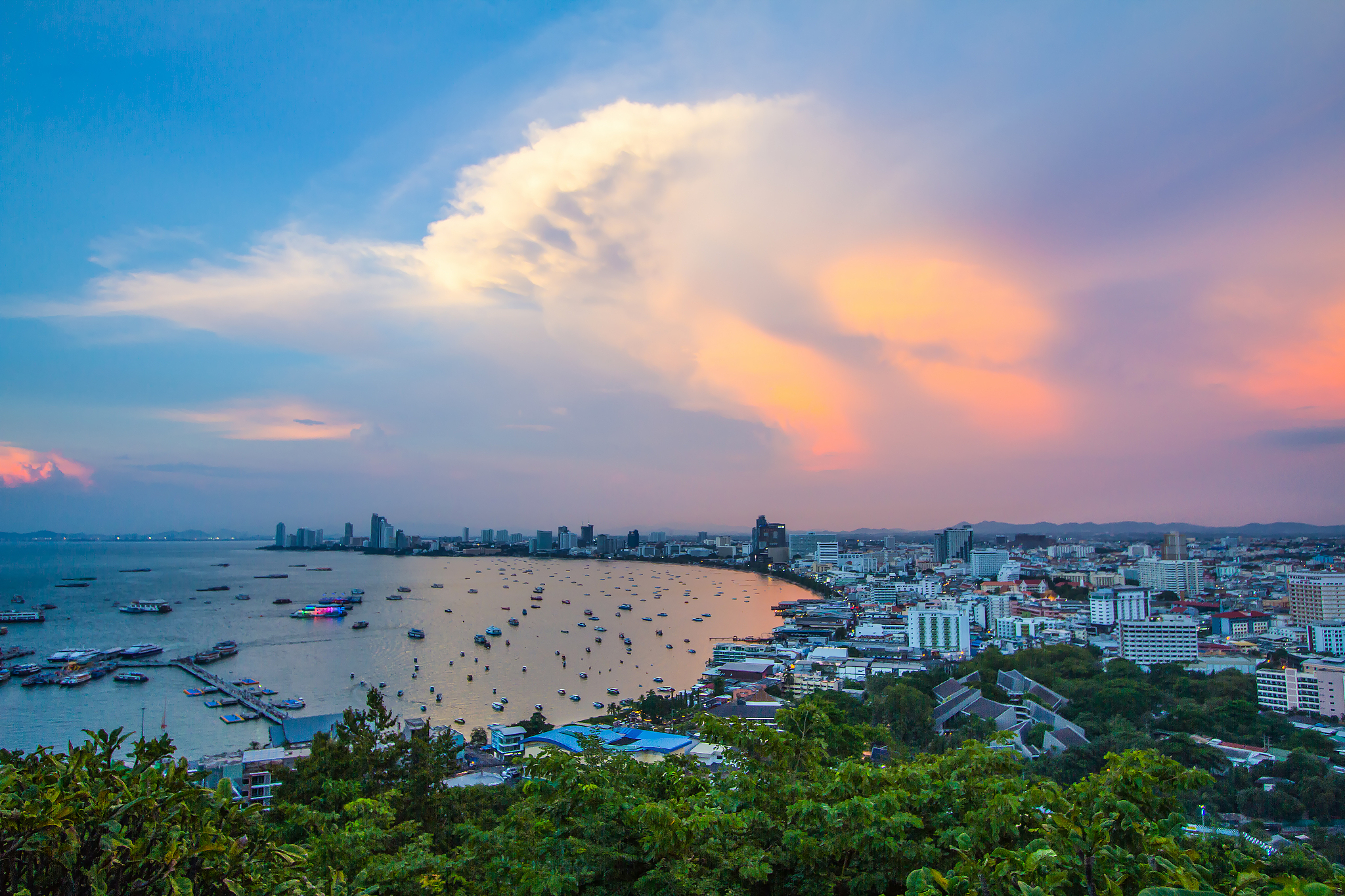 high angle view of sea and cityscape against sky