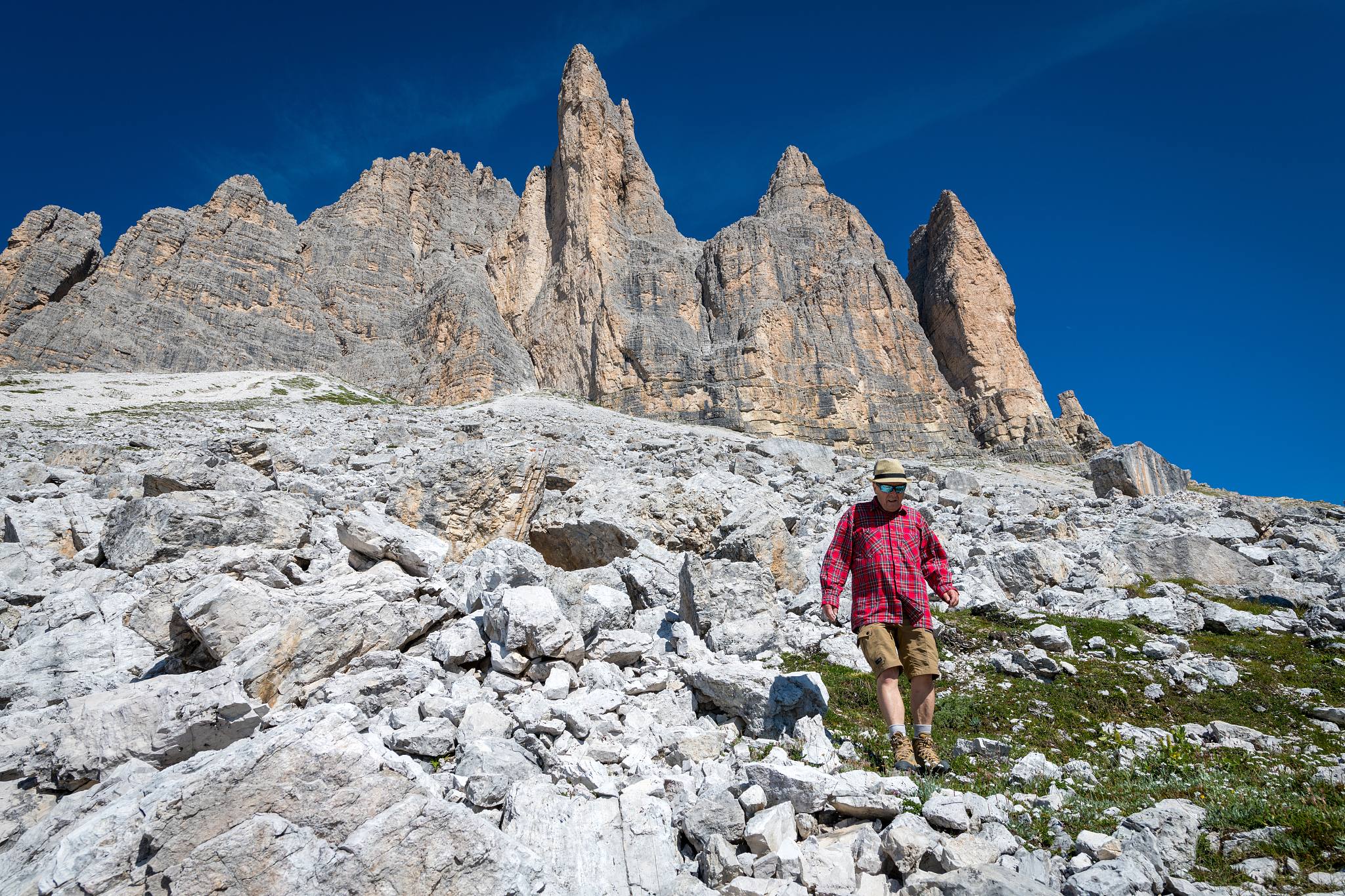 senior man hiking around tre cime di lavaredo in dolomites, euro