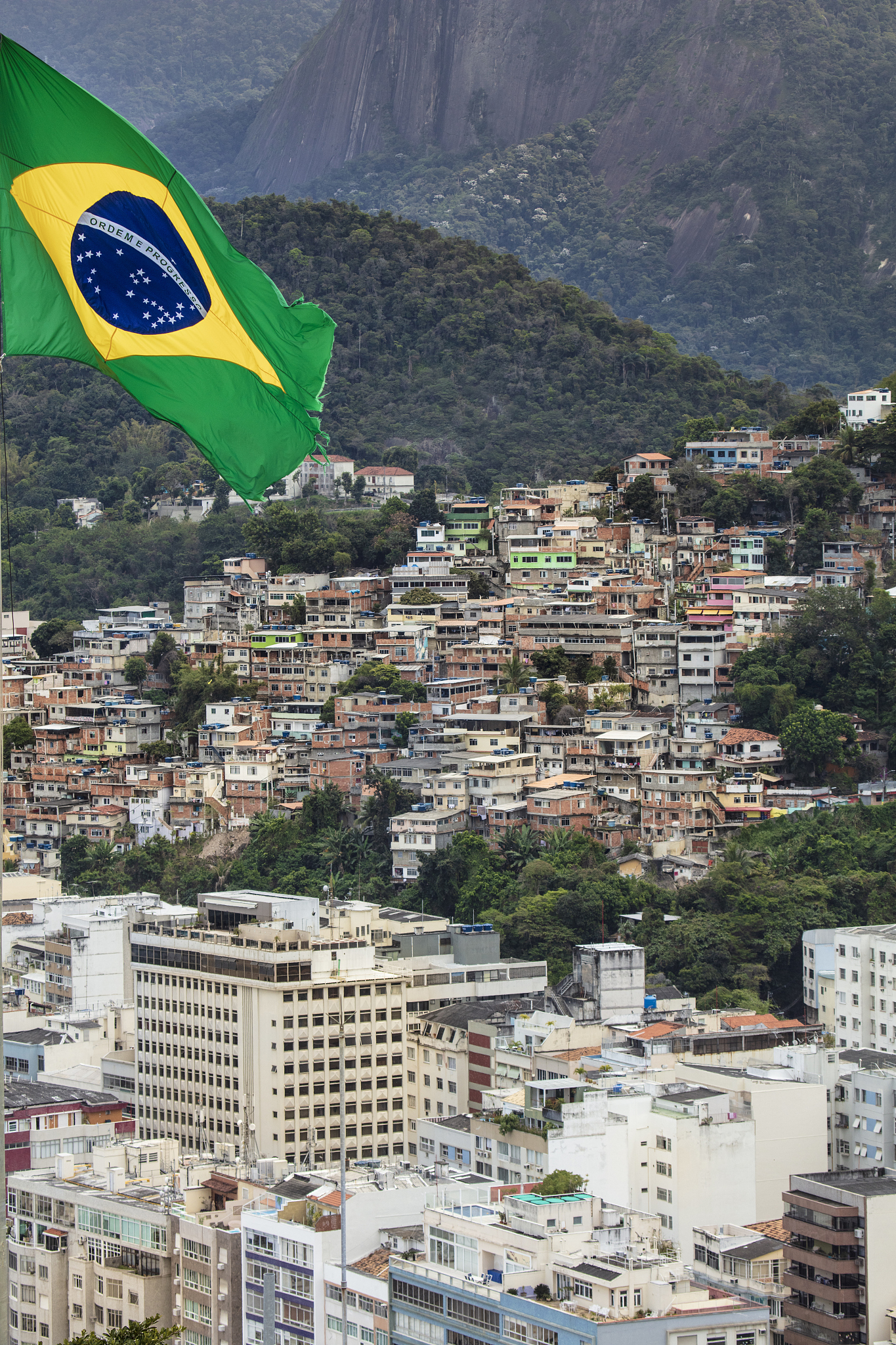 view of a favela slum in rio de janeiro with a brazilian flag fl