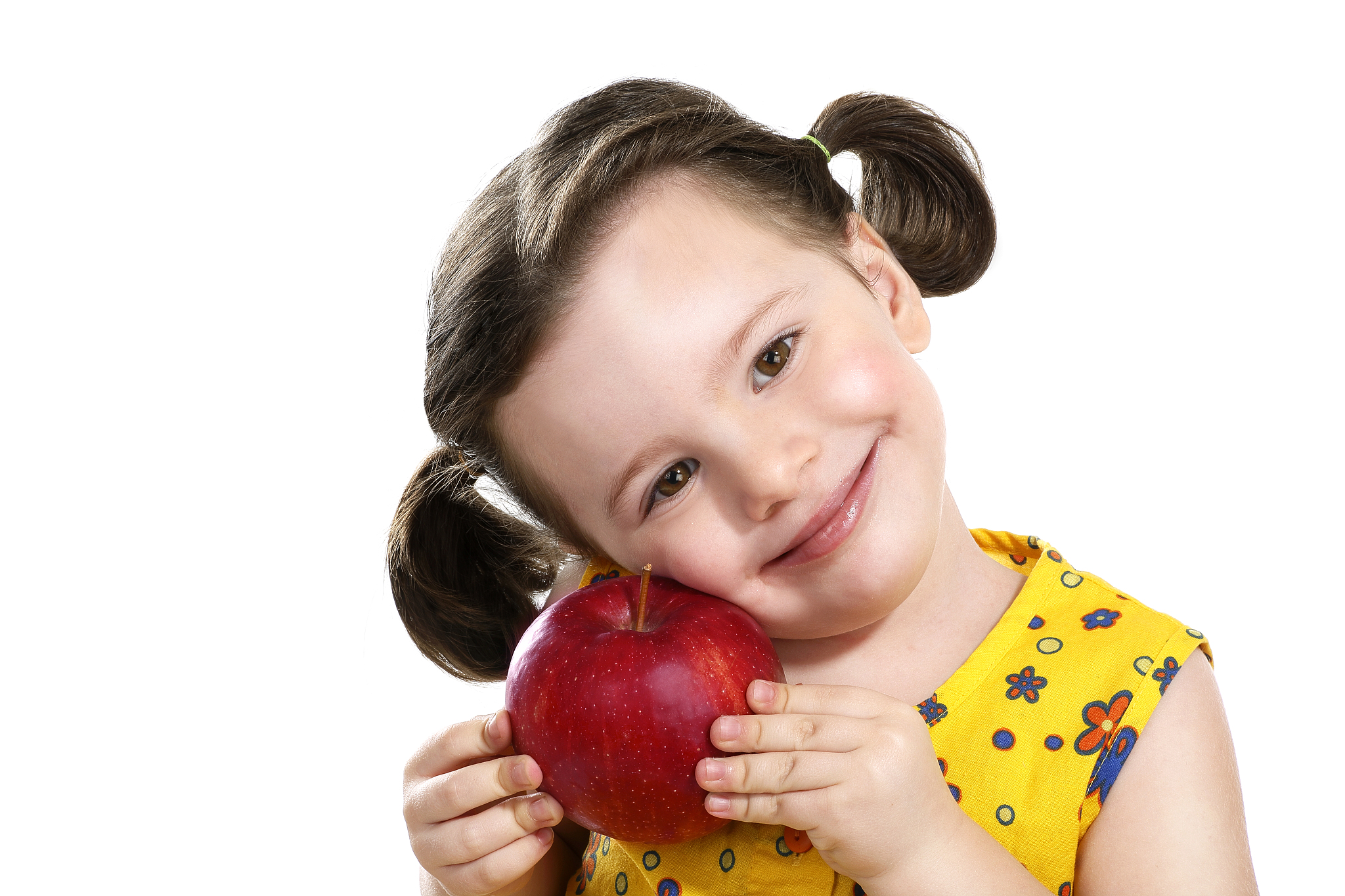 pretty child holding a red apple in her hands