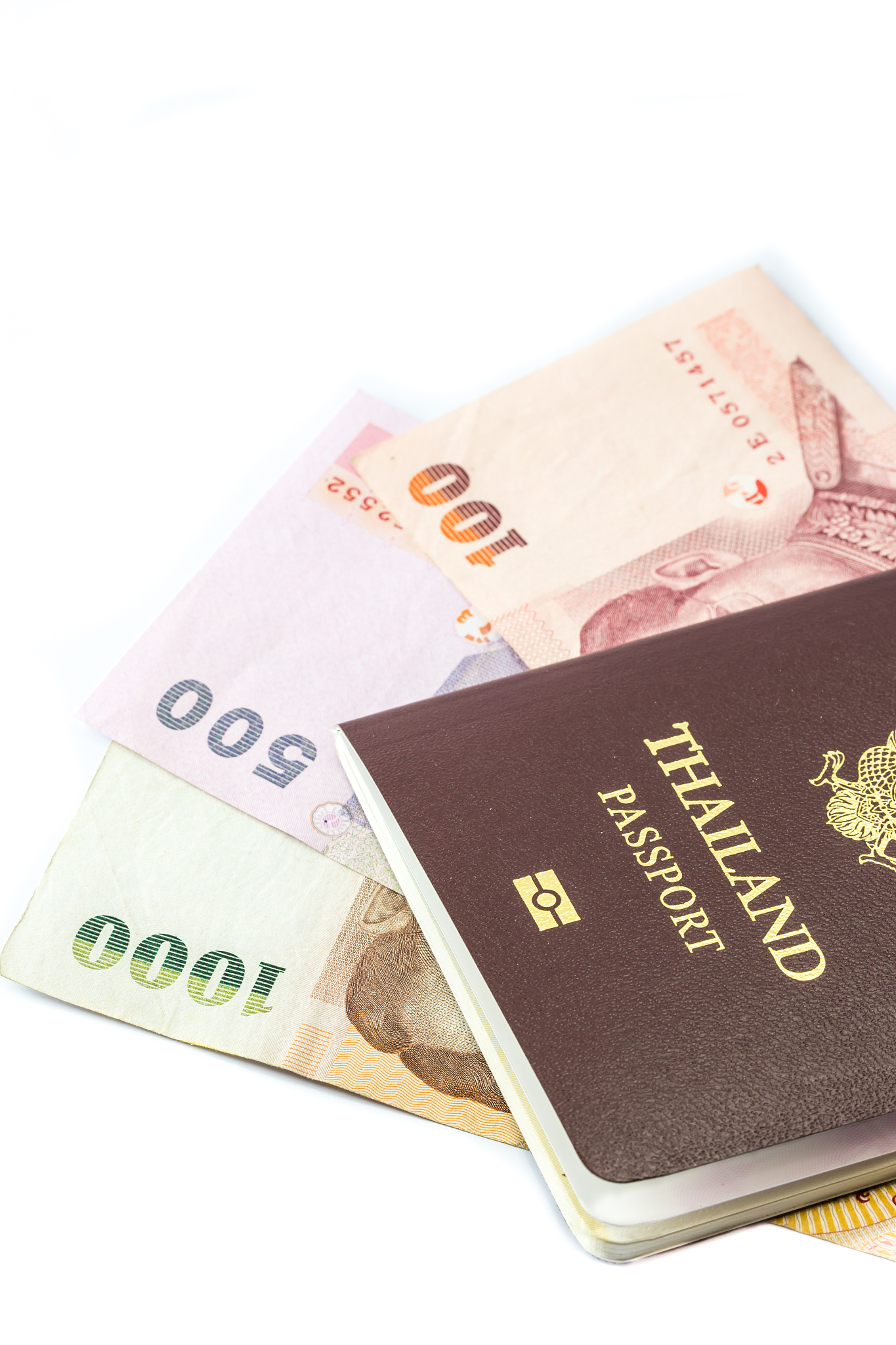thailand passport with thai money