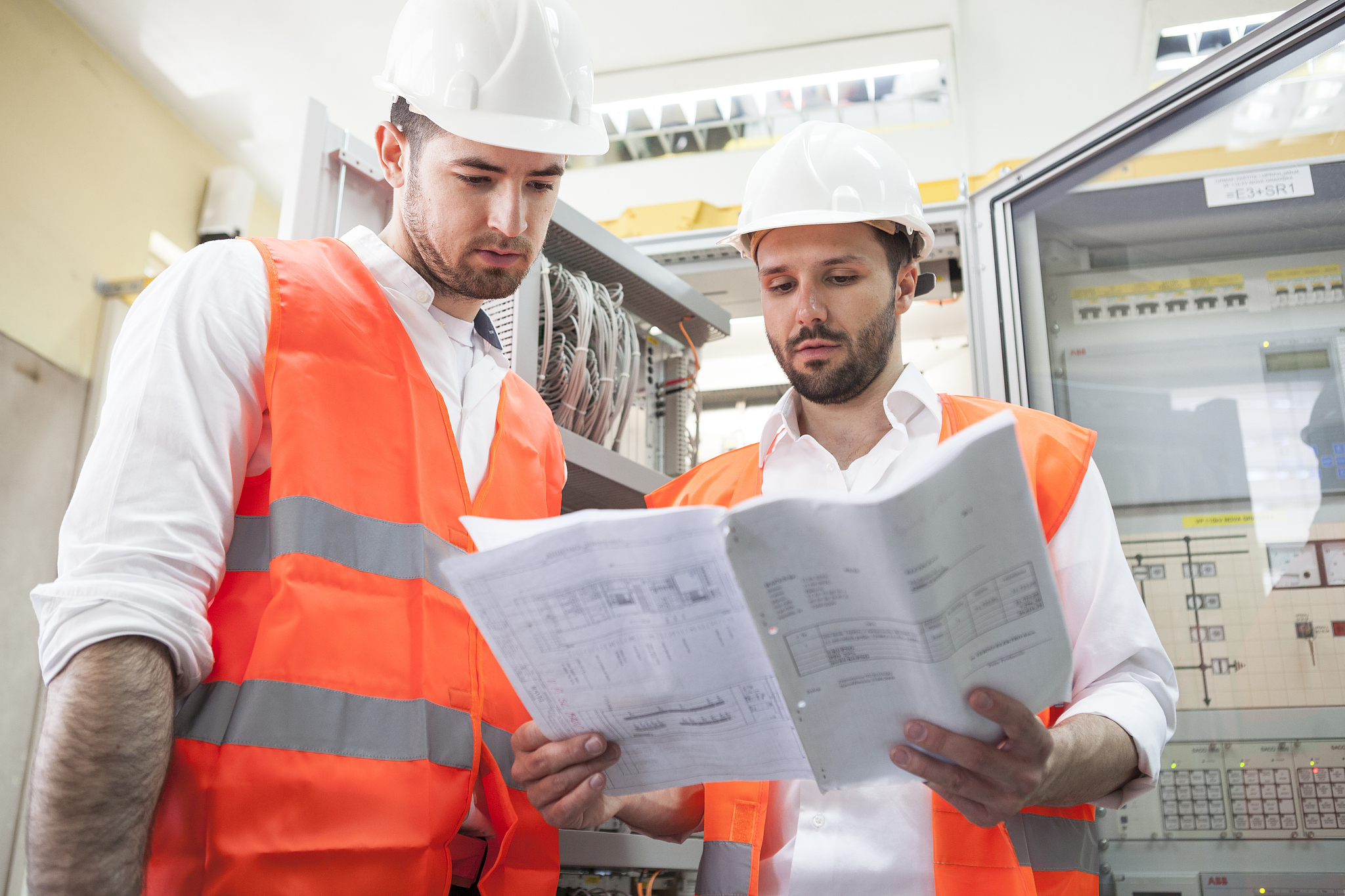 two engineers checking electricity substation