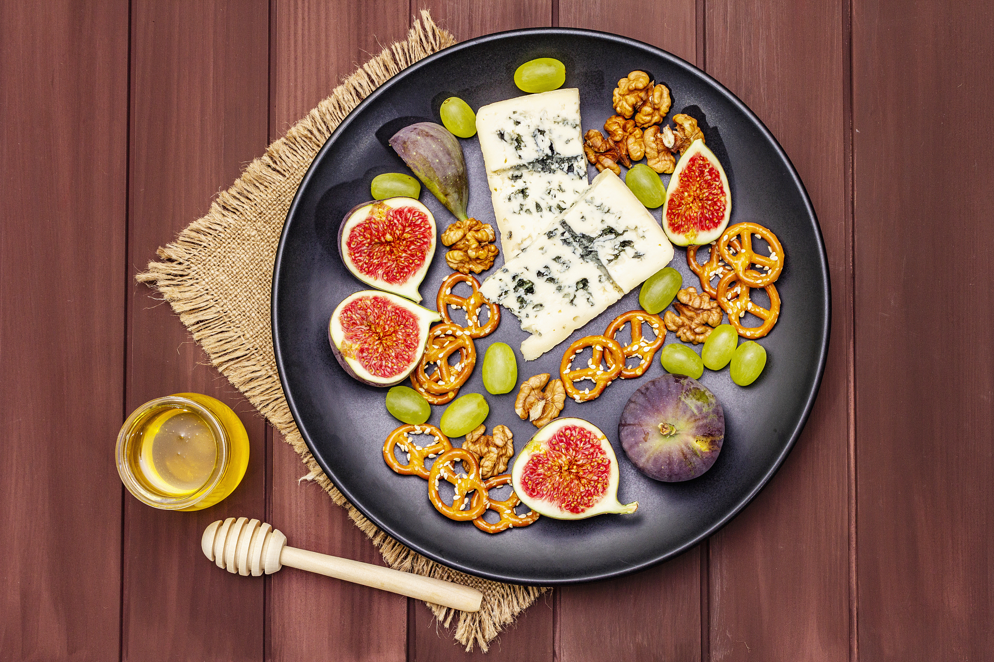 cheese plate with blue cheese, walnuts, figs, grapes, pretzels. 