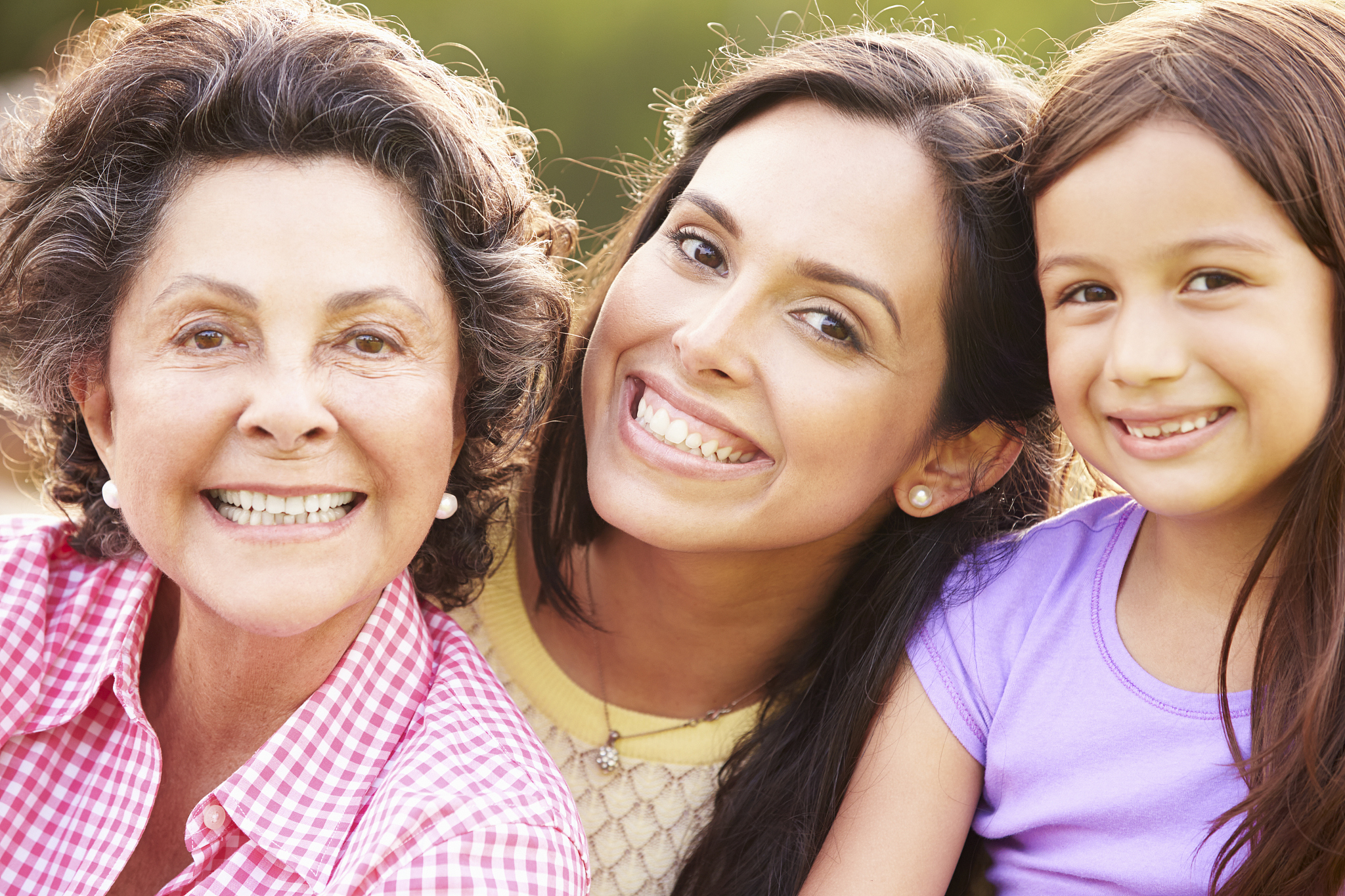 grandmother with granddaughter and mother in park