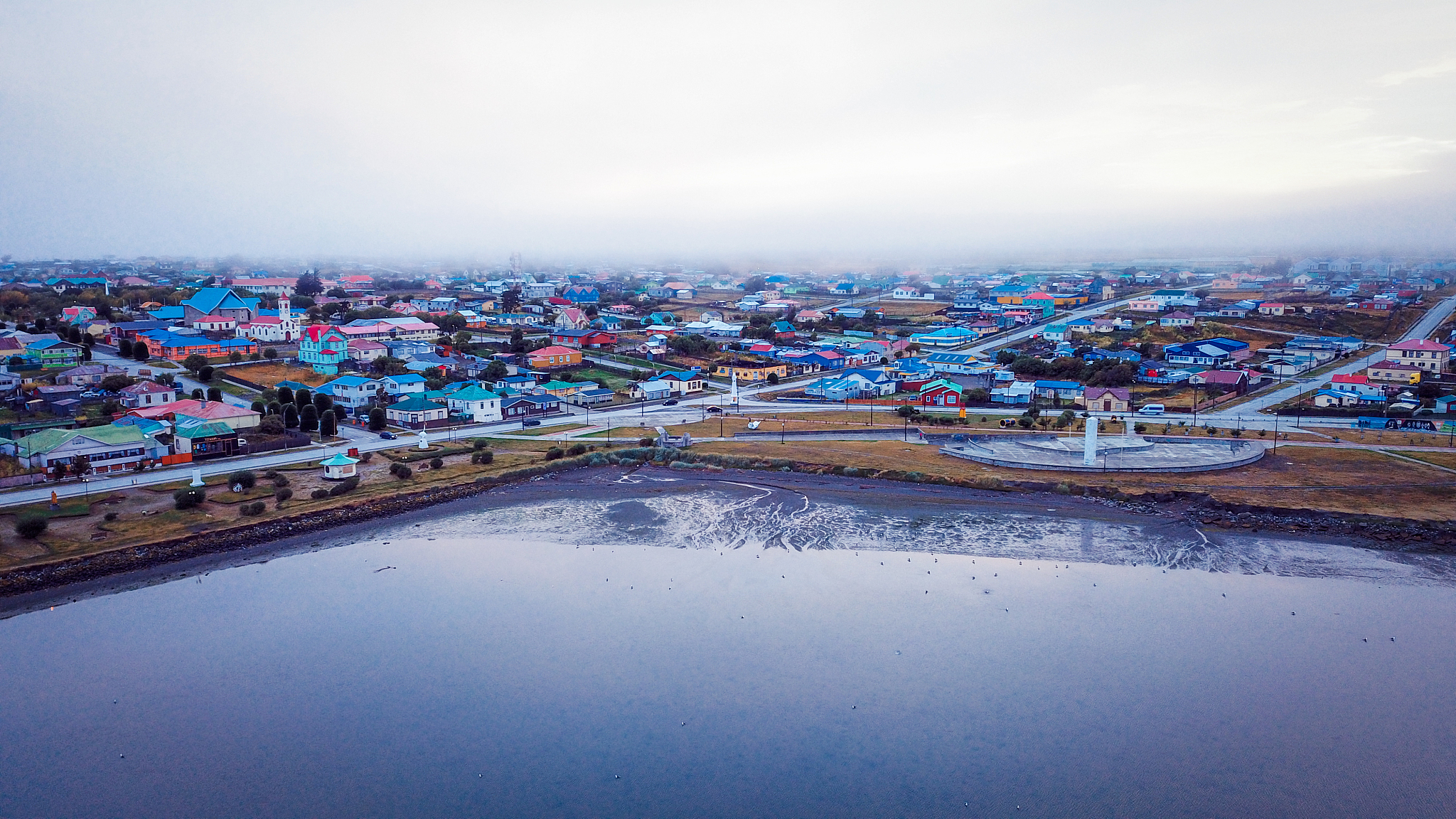 aerial view to the porvenir city under the sunset lights