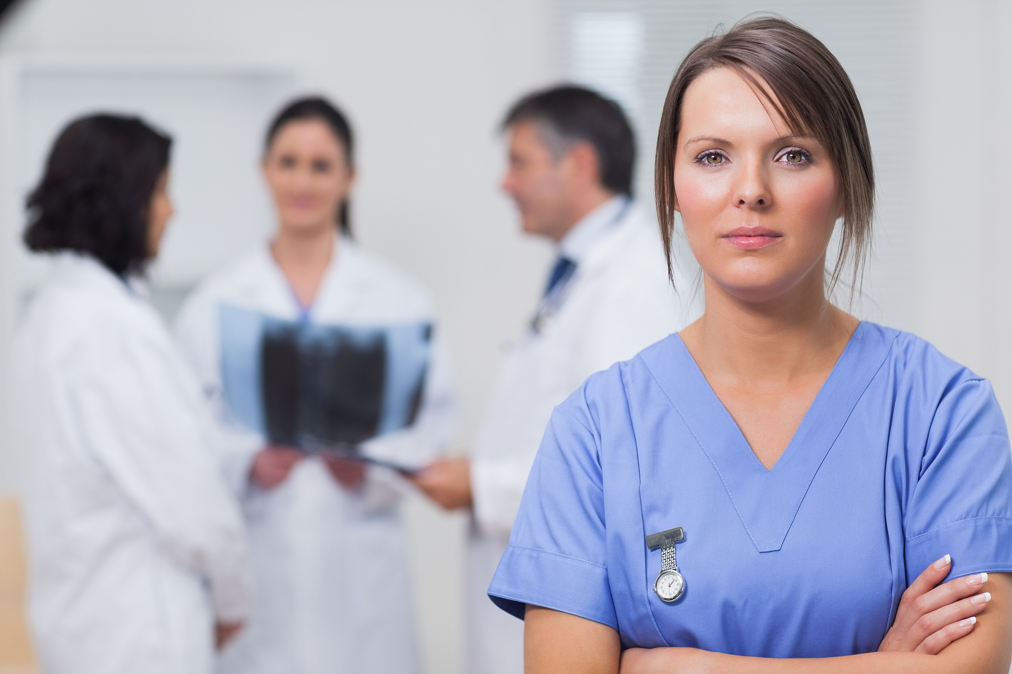 nurse standing seriously with her team