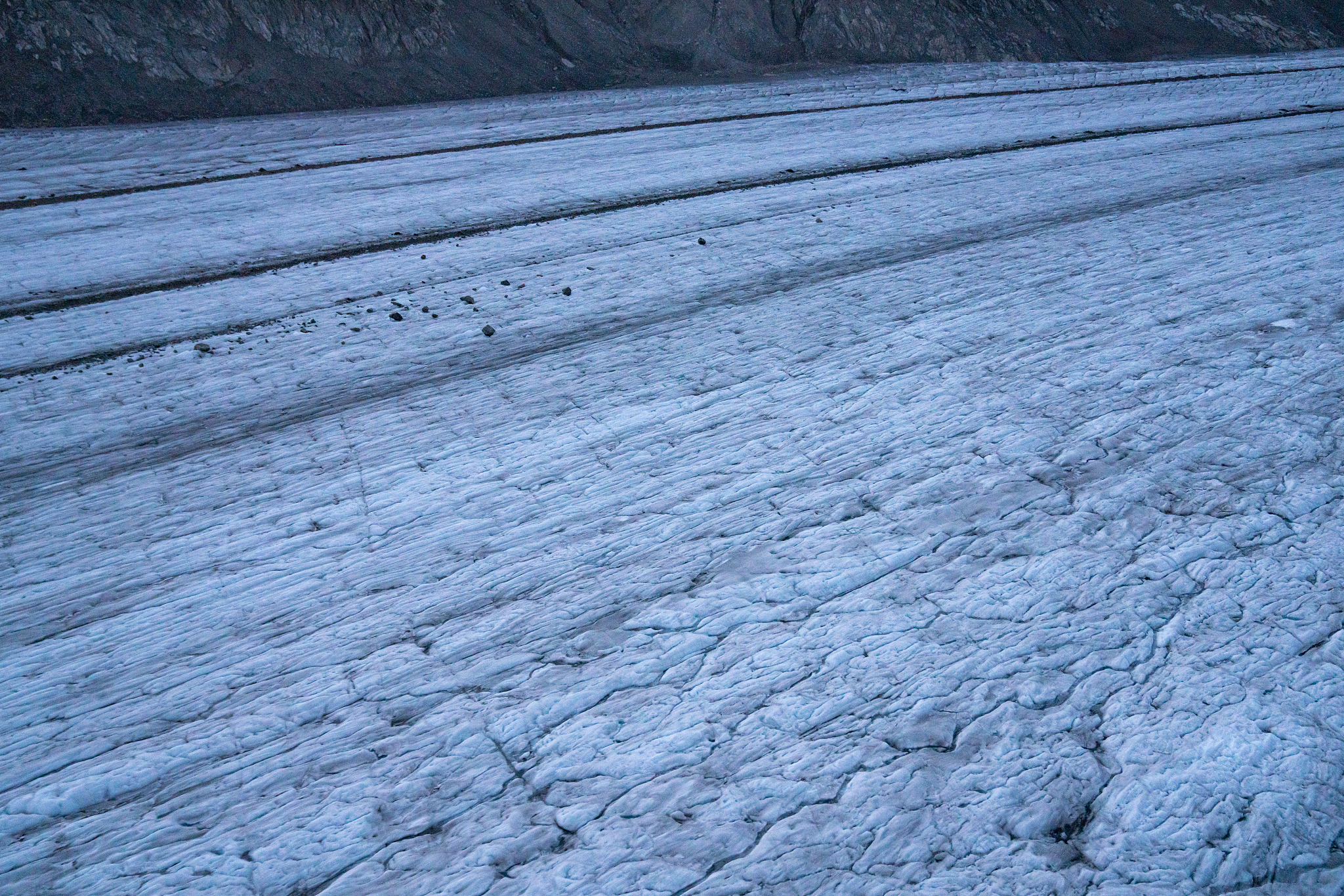 aerial flying over aletsch glacier looking down at ice in switze
