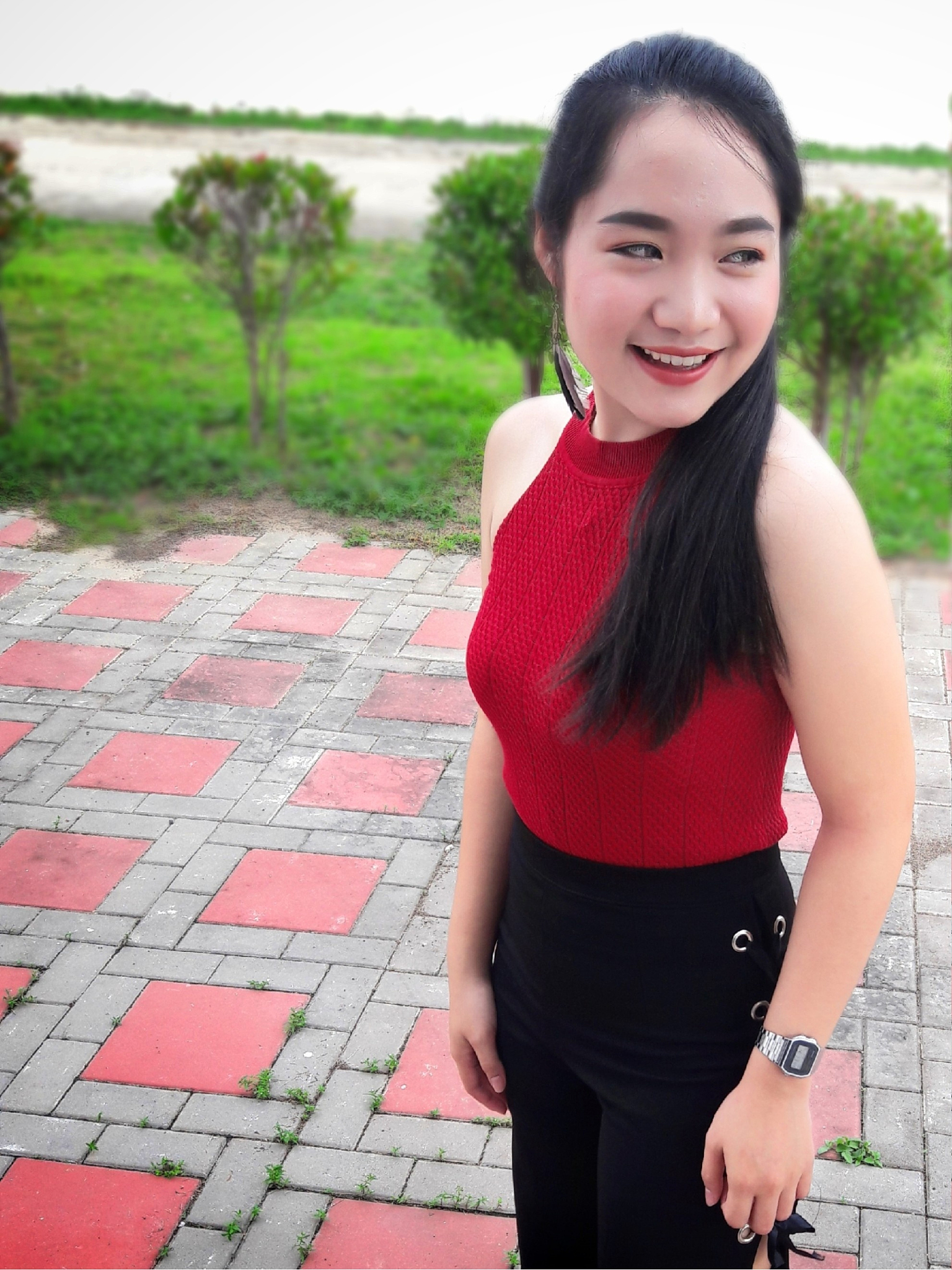 beautiful woman smiling while standing on footpath